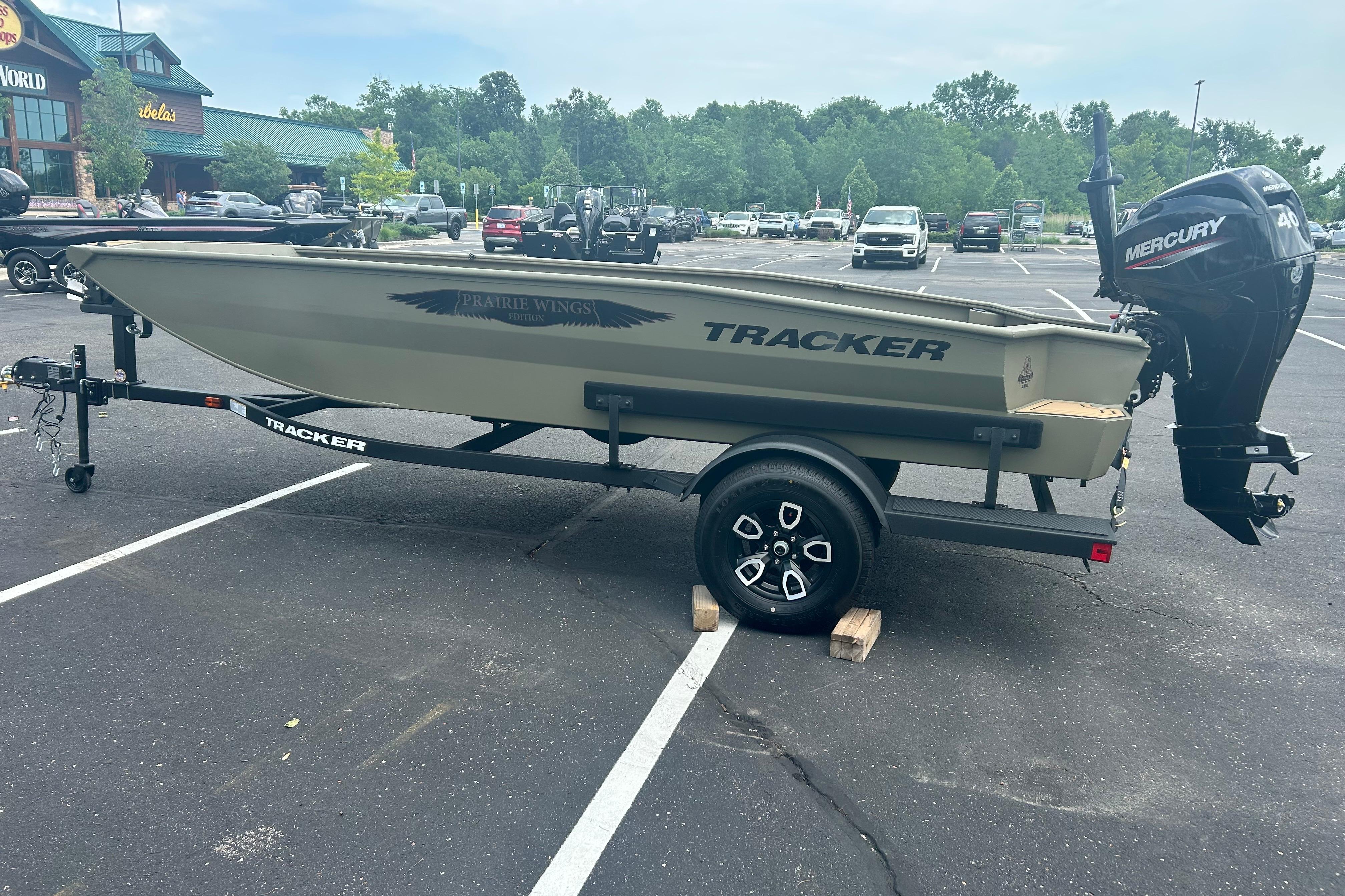 2026 Tracker Grizzly 1650 T Prairie Wings Edition boat on trailer in parking lot.
