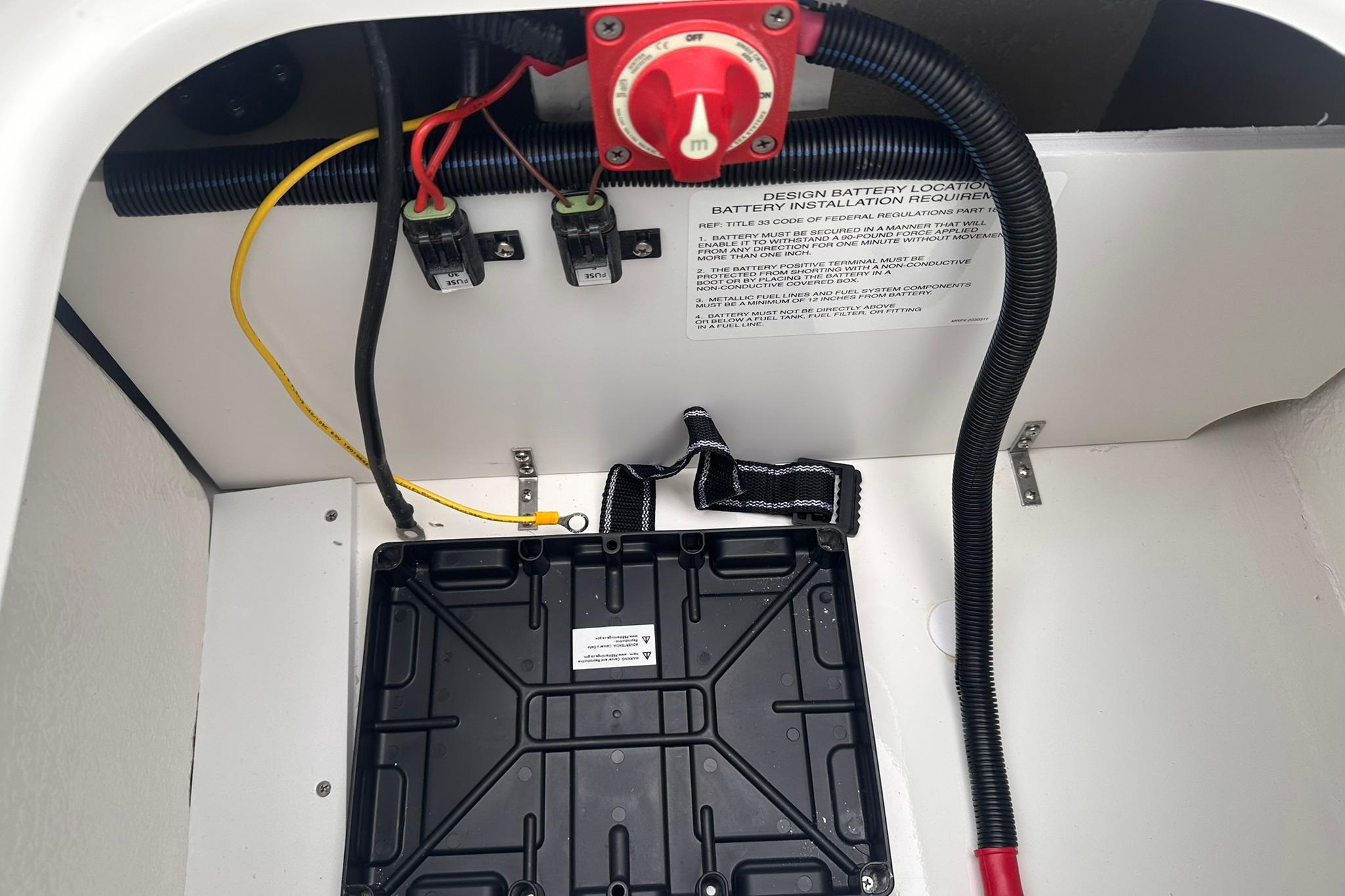 Battery compartment of 2026 Bayliner M17 boat with wiring and installation instructions.