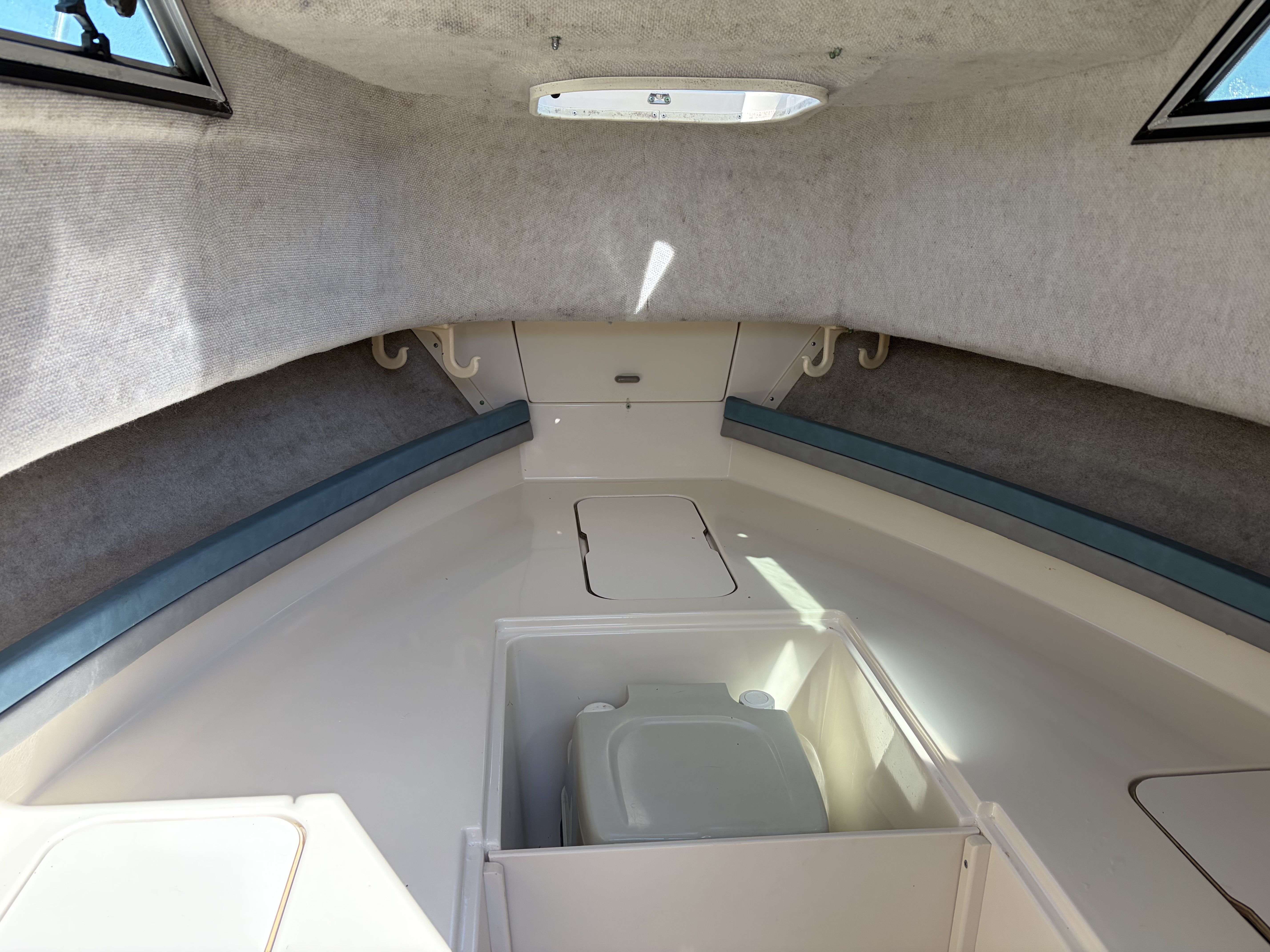 Interior of a 1993 Grady-White Adventure 208 with a small toilet and storage space.