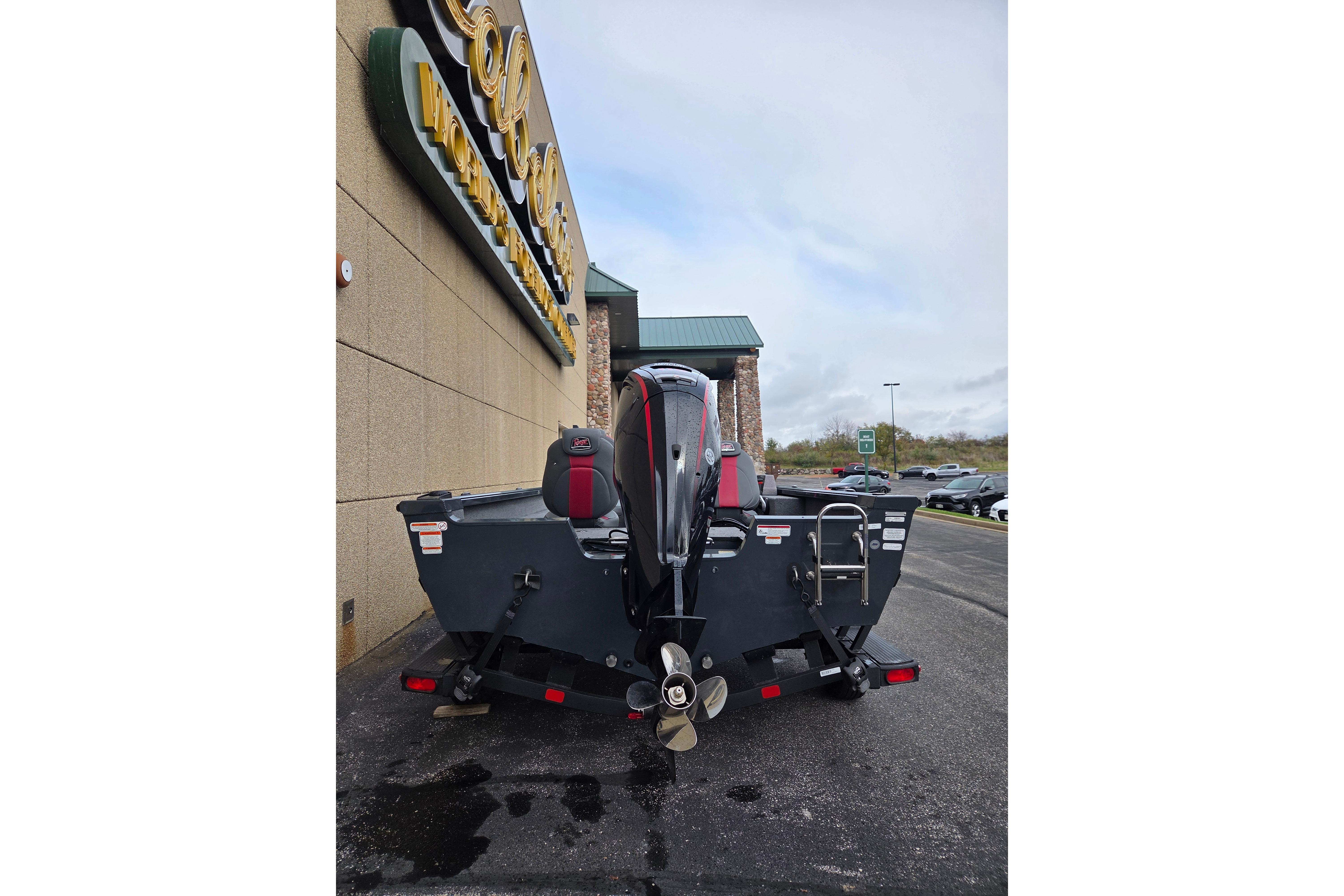 2025 Ranger VS1682SC Angler boat parked outside a store, rear view.
