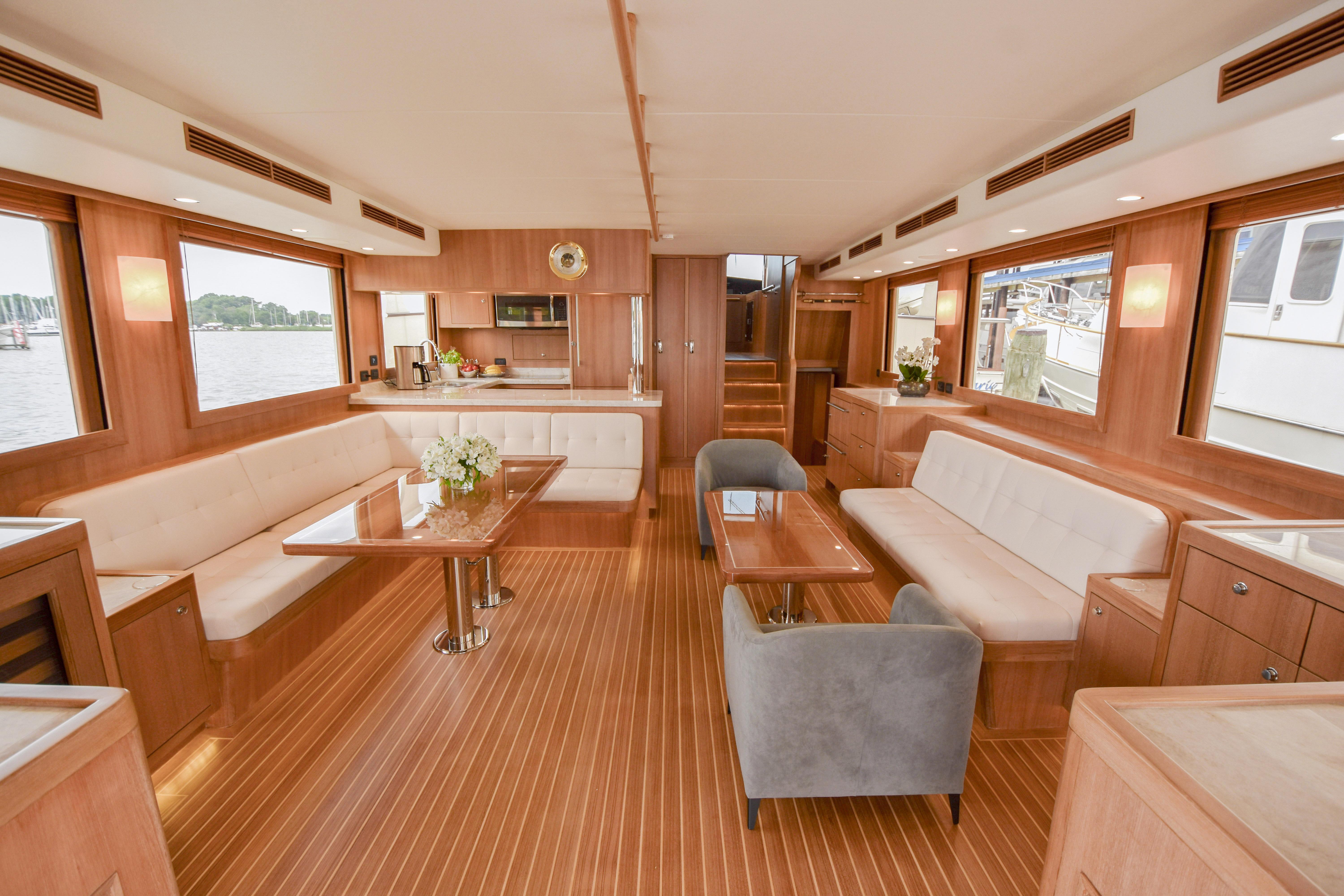 Luxurious interior of 2020 Fleming 78 yacht with elegant wood finish and spacious seating.