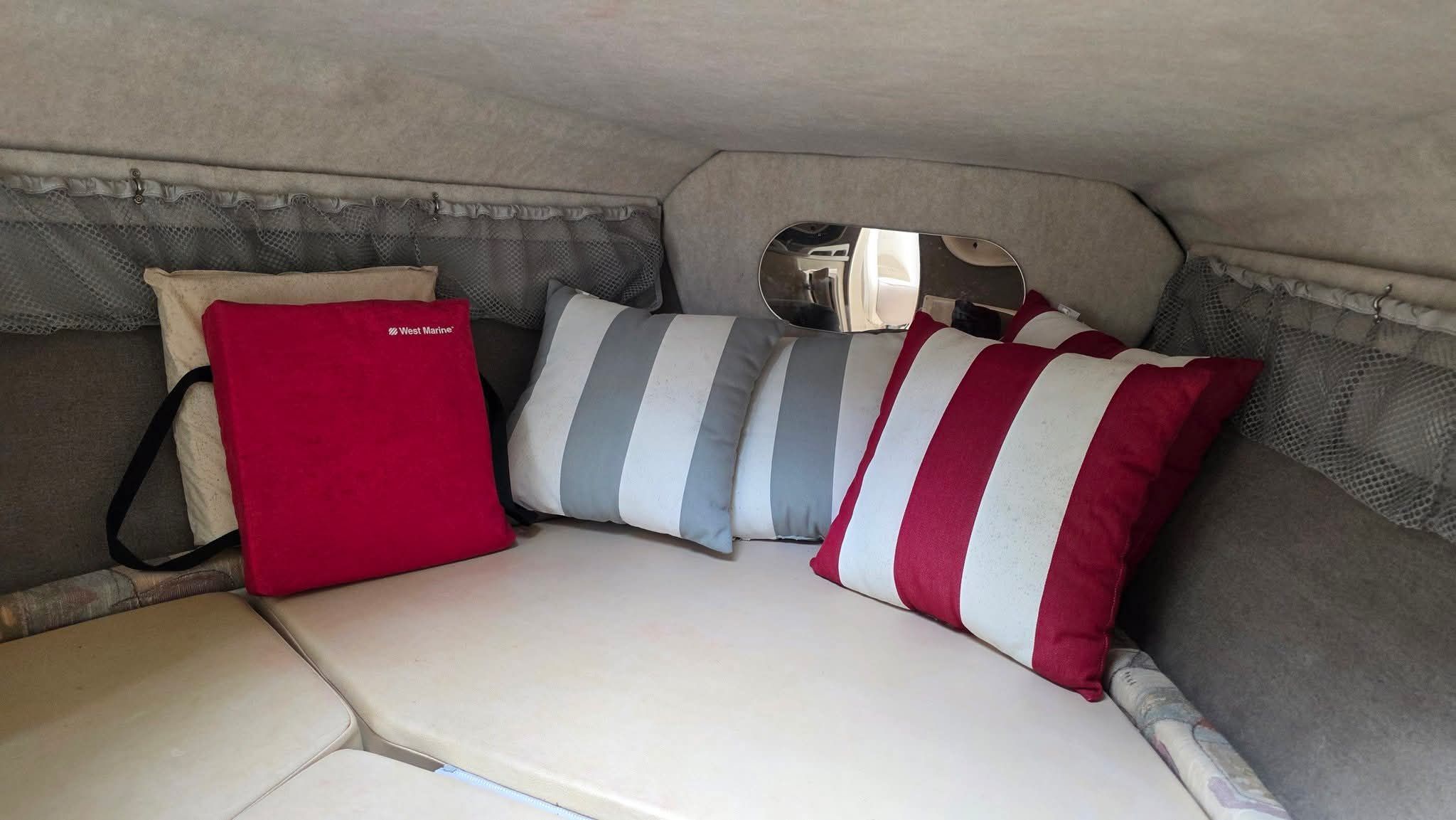Interior of the 2006 Stingray 250 CR with cozy cushions and a small window.