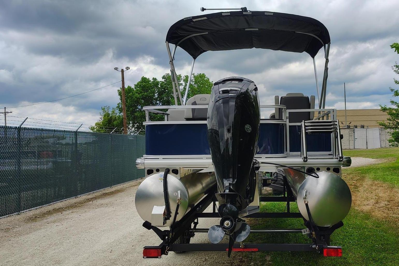 2026 Sun Tracker Bass Buggy 18 DLX on trailer, cloudy sky.