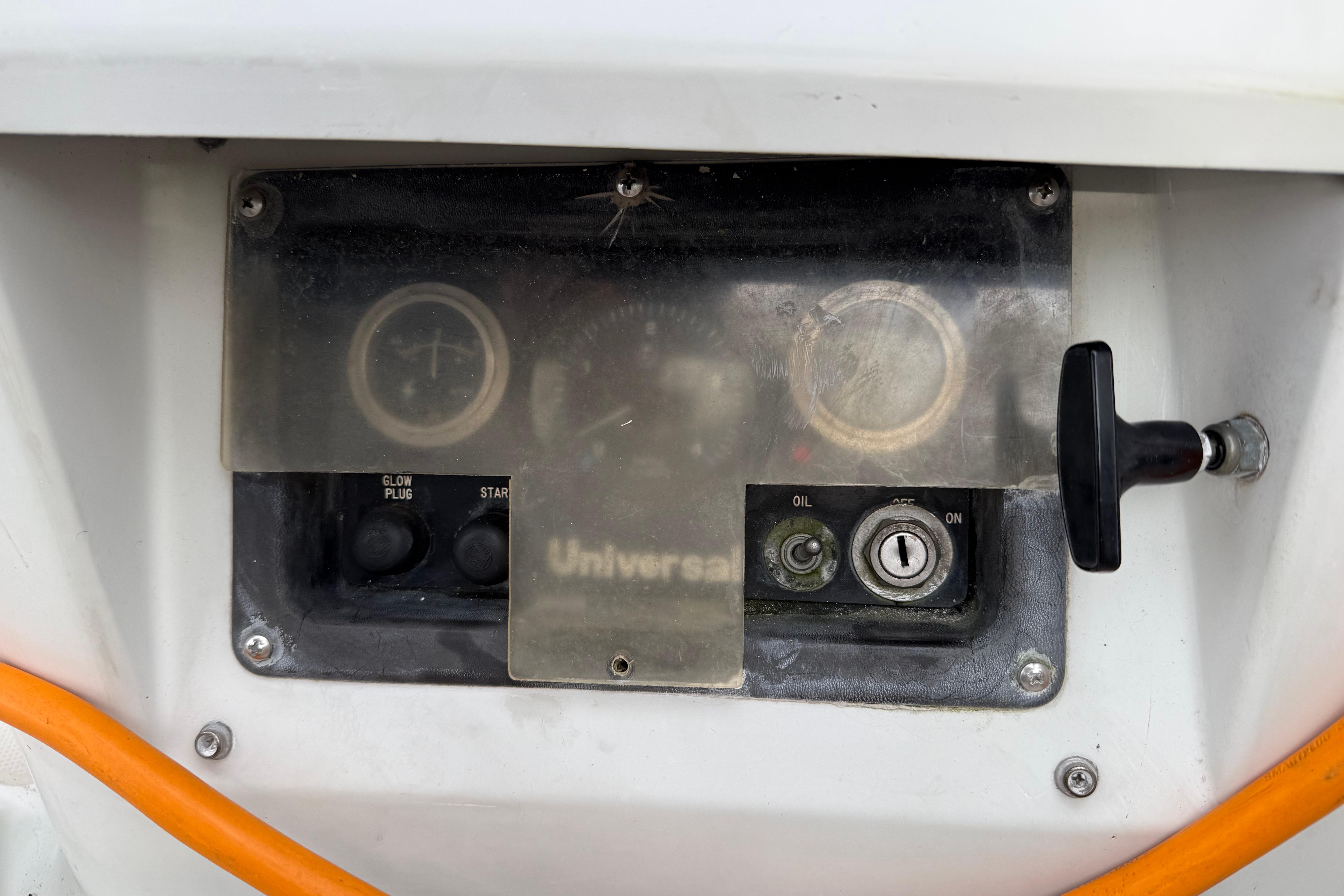 Control panel of a 1988 Ericson 32-200 sailboat with gauges and switches.