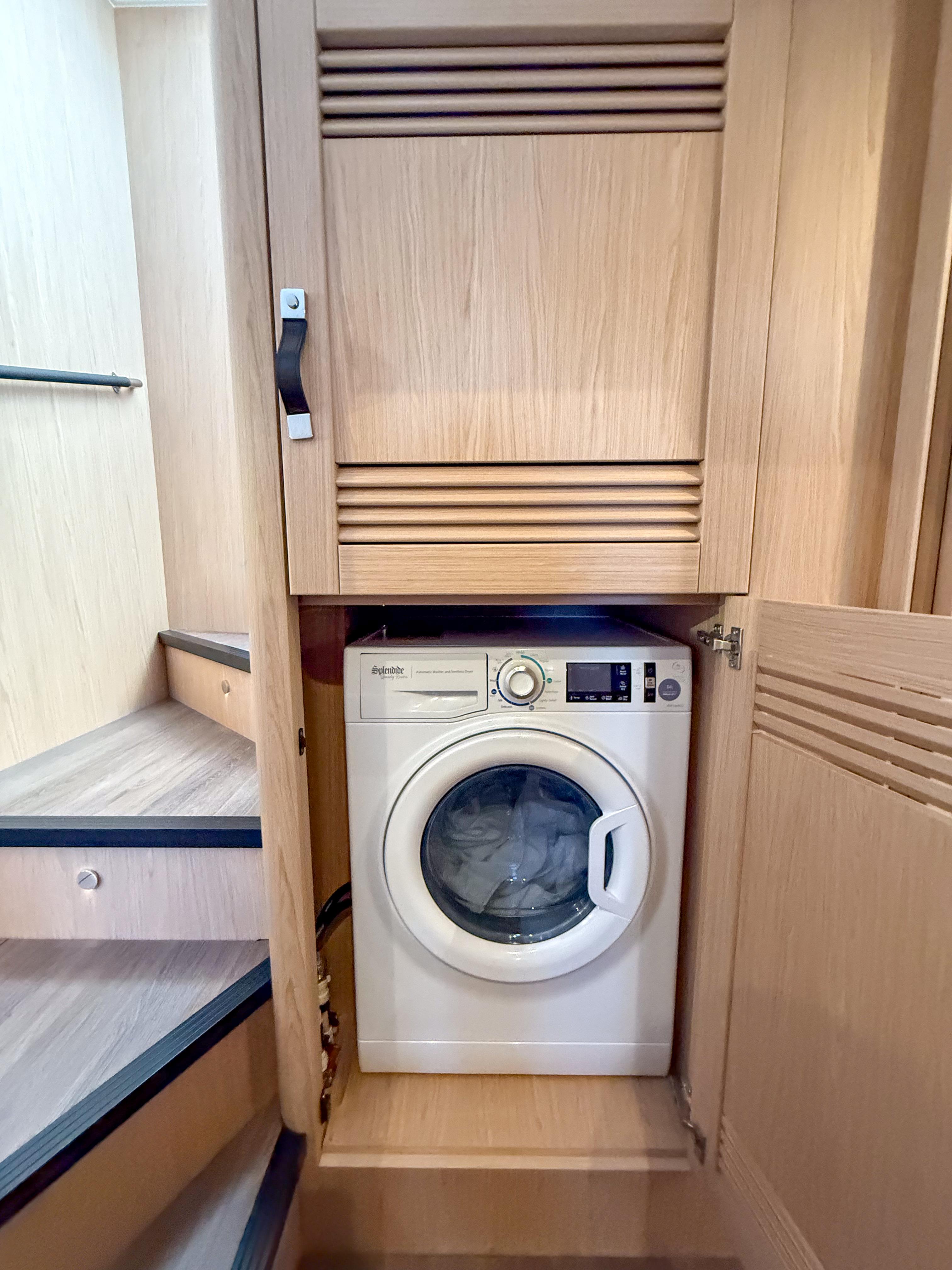 Laundry area with washing machine in 2026 Beneteau Swift Trawler 54 yacht.
