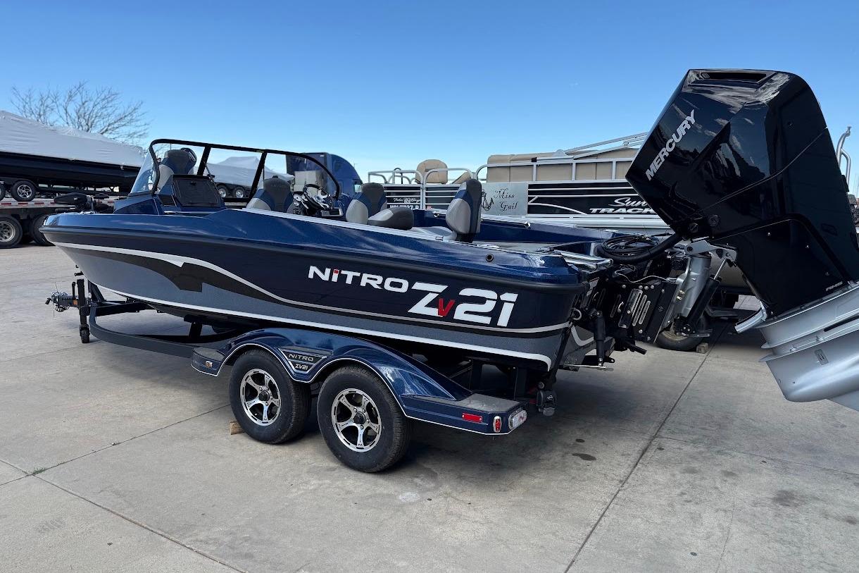 2026 Nitro ZV21 Pro boat with Mercury engine on trailer, parked outdoors.
