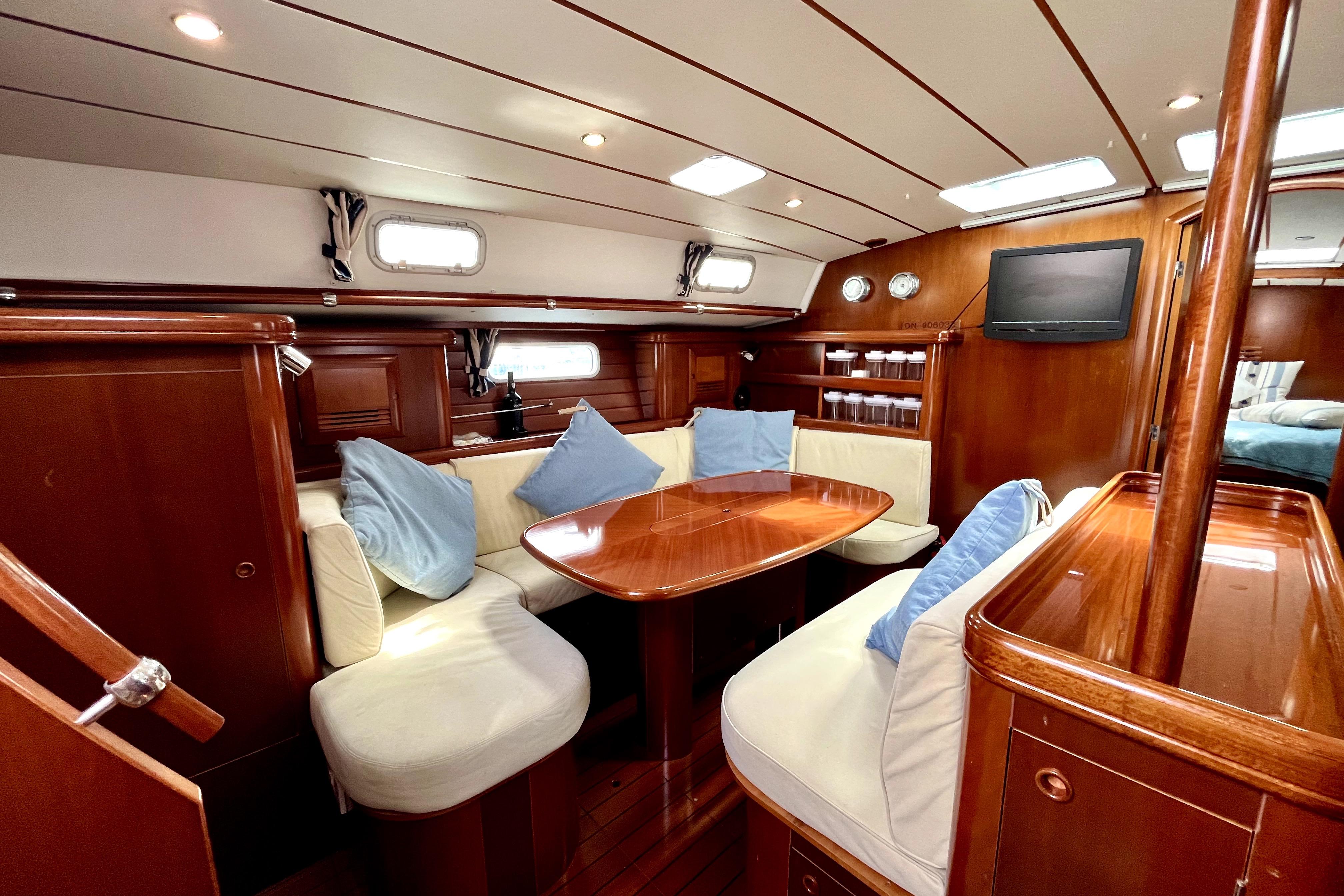 Luxurious interior of a 2003 Beneteau 50 yacht with elegant wood finish.