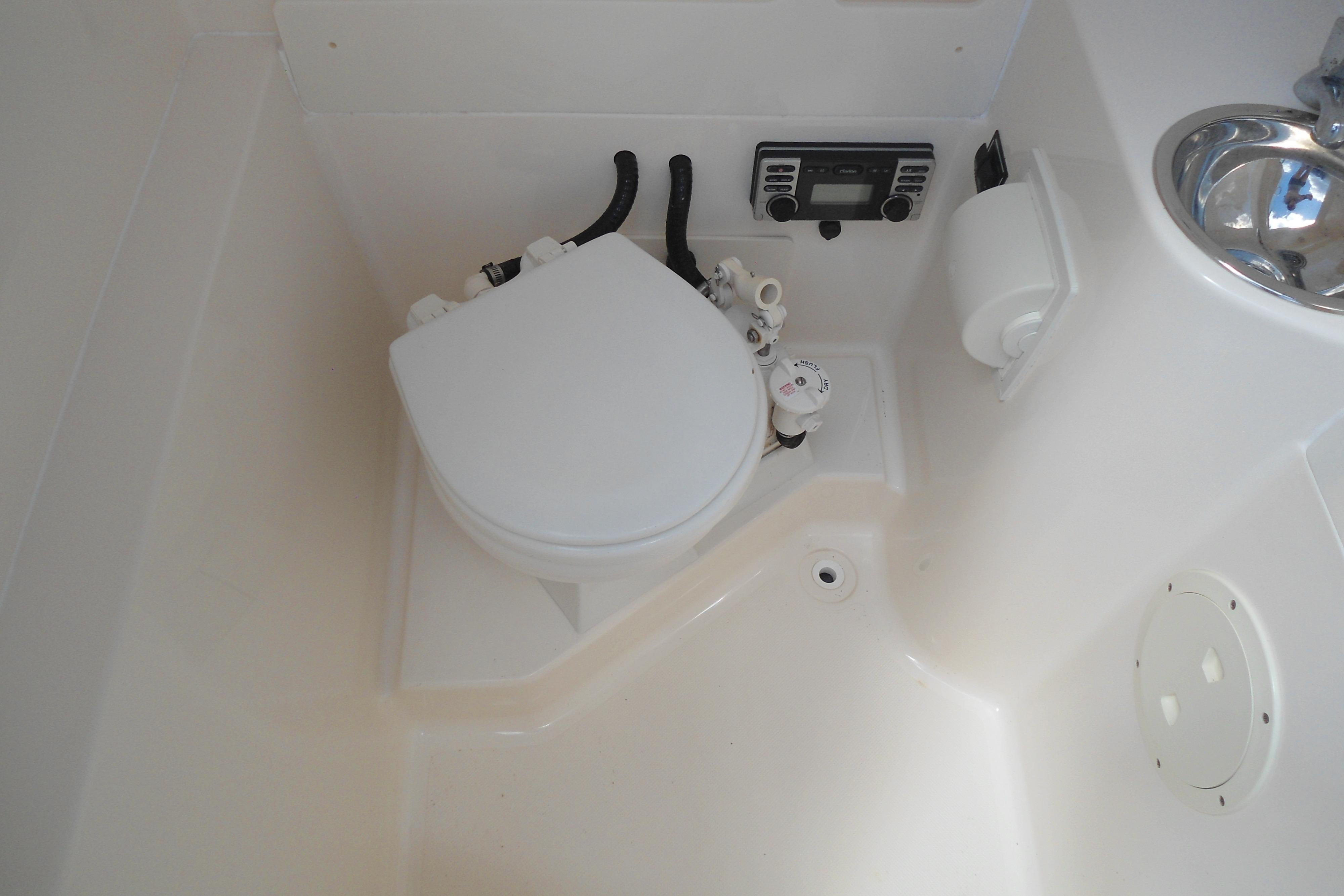 2013 Pursuit C 260 Center Console boat bathroom with toilet and sink.