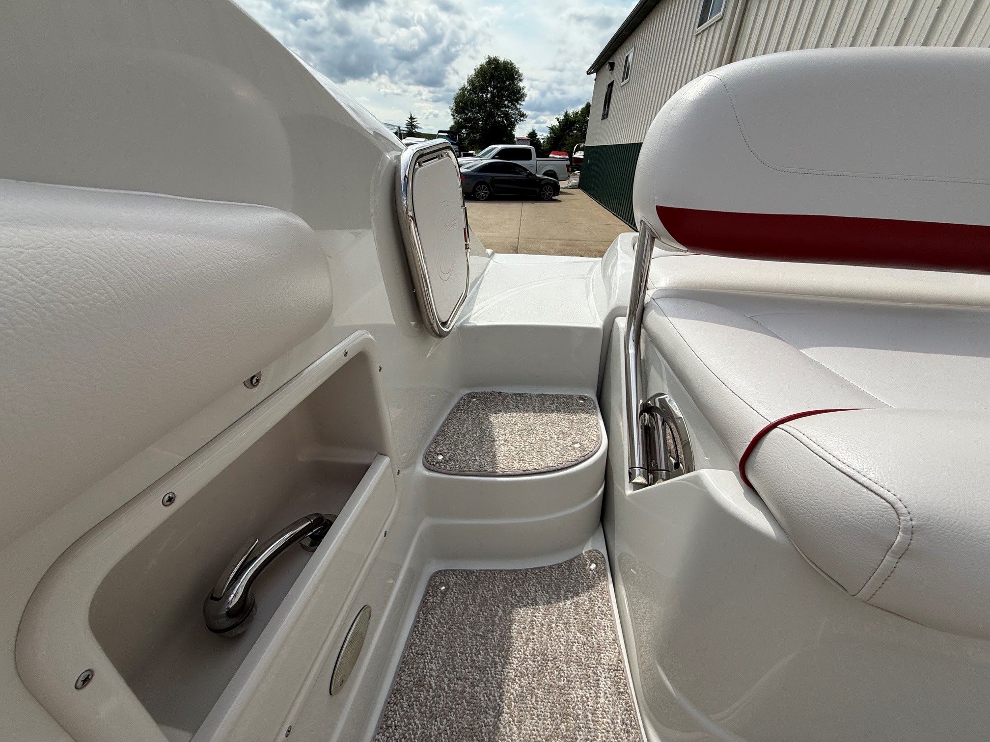 Close-up of a Crownline 252 EX boat interior with white seating and storage compartments.