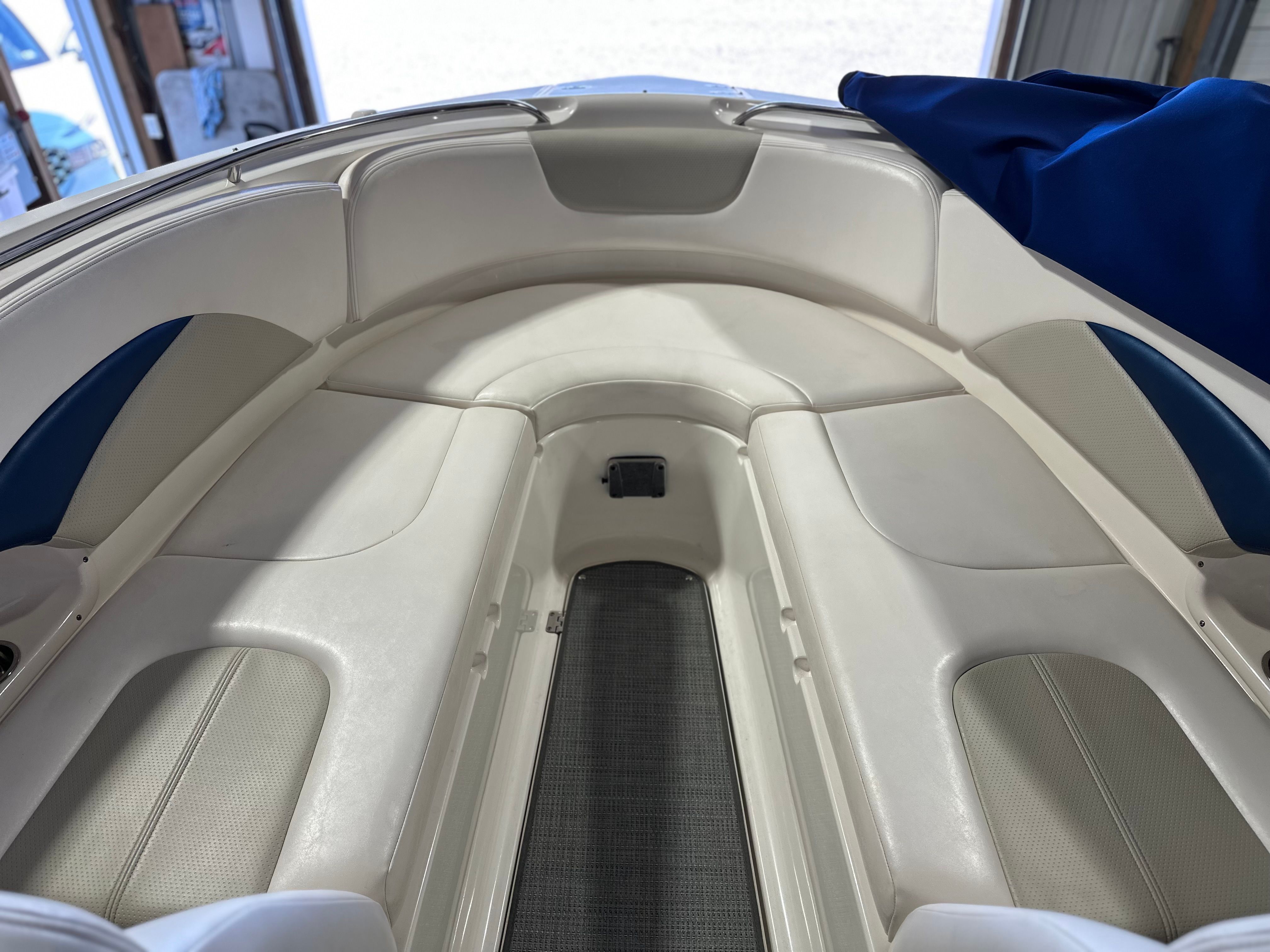 The image shows the bow area of a Chaparral 287 SSX boat with white upholstery.