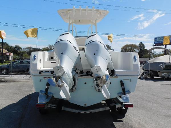 2024 Sailfish 242 CC boat with twin outboard engines, rear view.