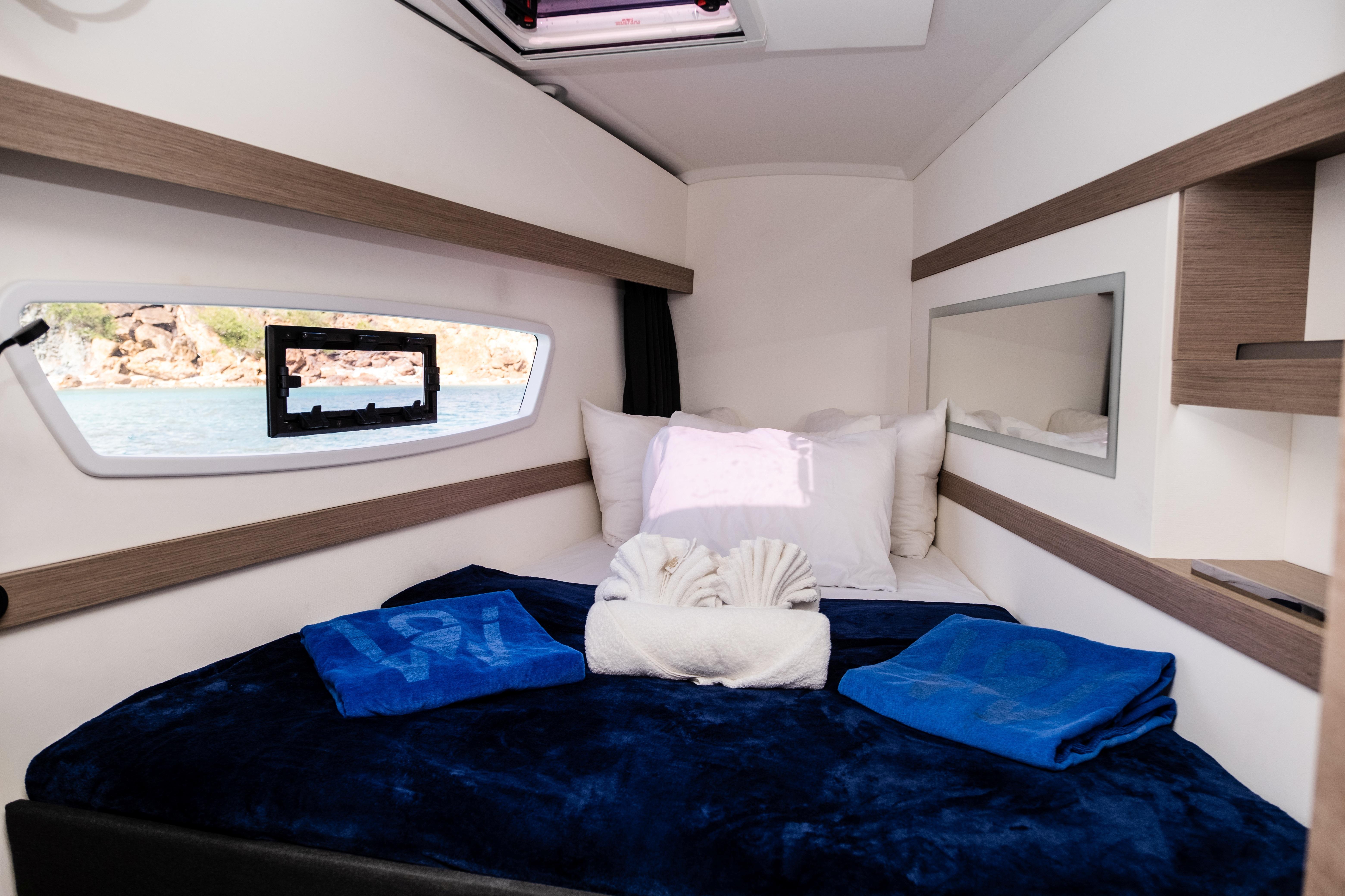 Luxurious cabin interior of 2023 Fountaine Pajot Isla 40 catamaran with cozy bedding.
