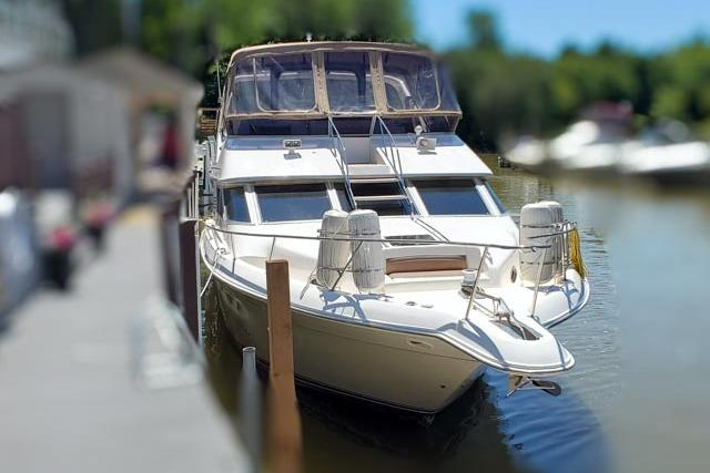 1995 Sea Ray 440 Express Bridge docked on a sunny day.