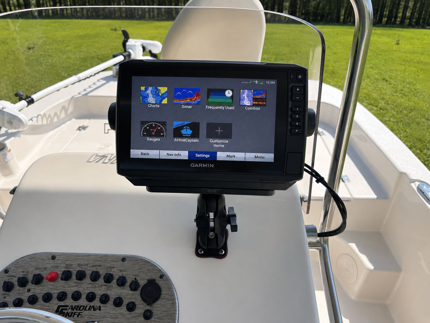 The image shows the cockpit of a Carolina Skiff 17 LS with a Garmin navigation system.