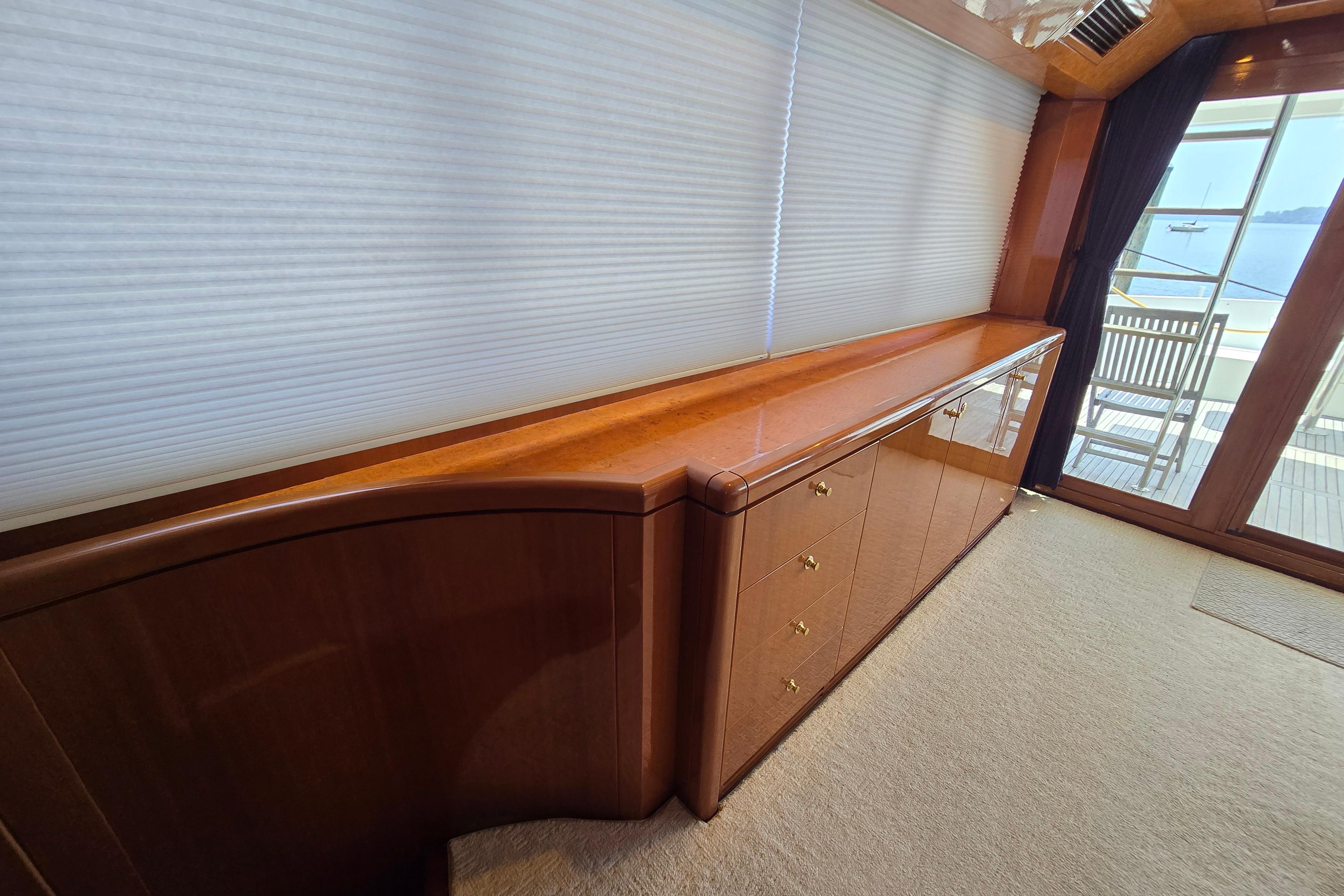 Luxurious interior of 2004 Grand Harbour 58 yacht with wooden cabinetry and large windows.