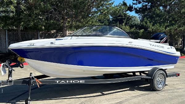 2024 Tahoe 200 S boat on trailer, blue and white design, parked outdoors.