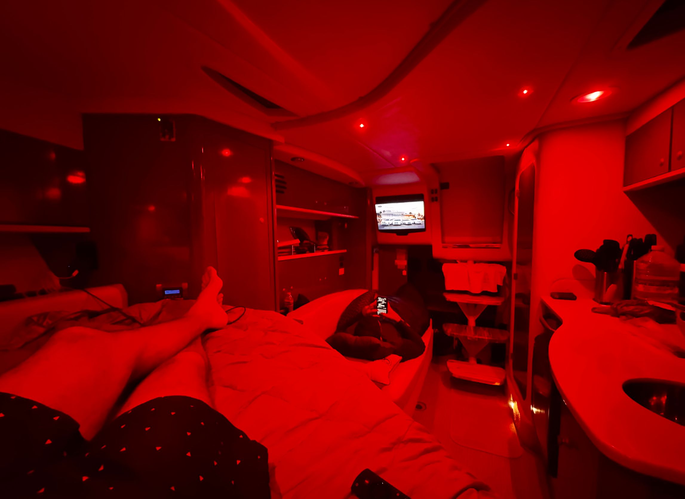Interior of a Sea Ray Sundancer 310 yacht, red lighting, cozy atmosphere.