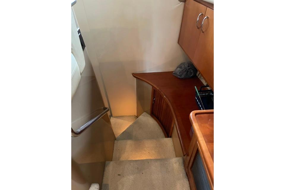 Interior stairs of 2003 Carver 36 Super Sport yacht with wooden cabinetry.