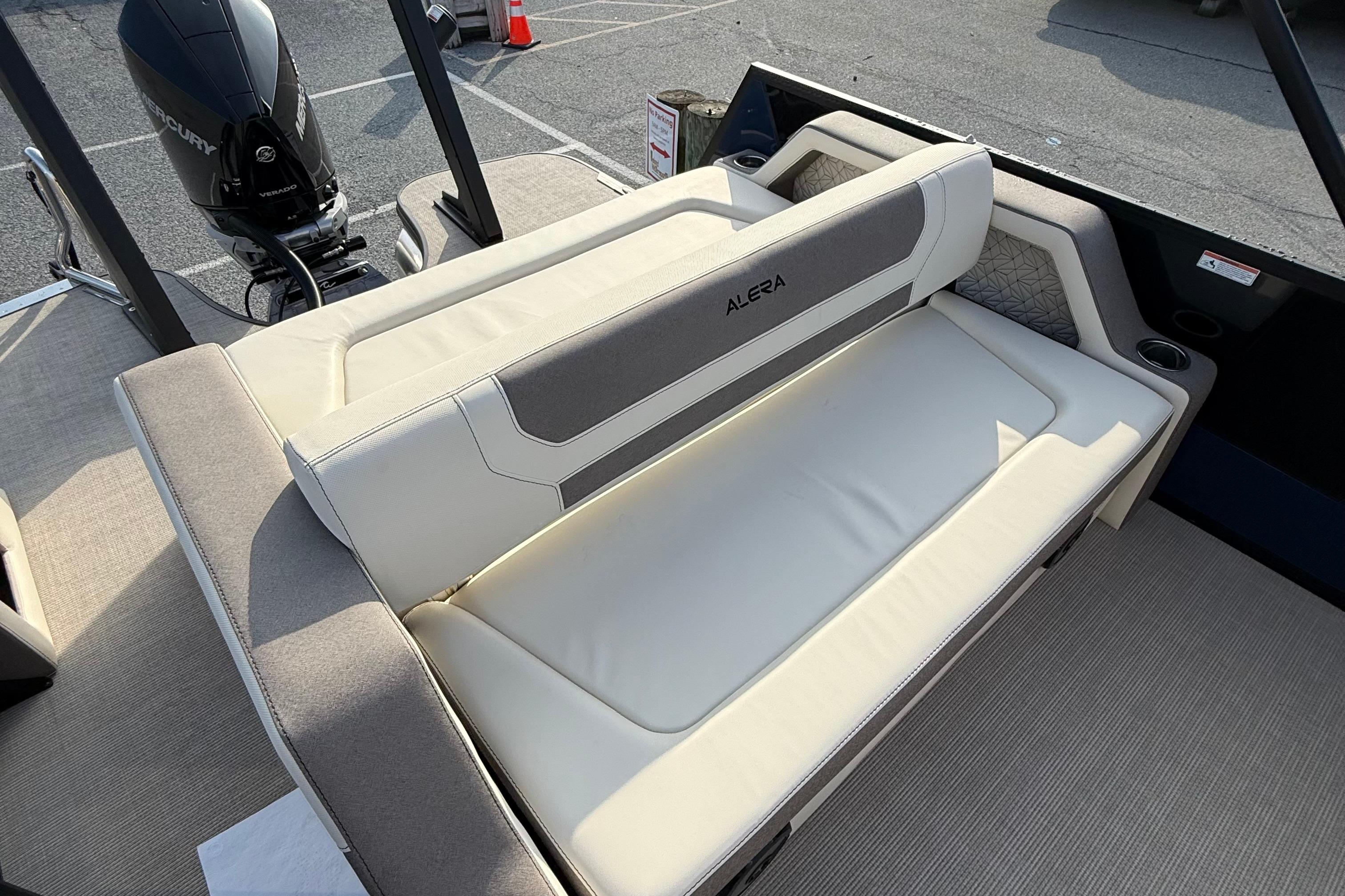 2026 Alera M23L boat interior with cushioned seating and Mercury outboard motor.