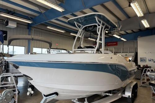 2025 Crownline 230 FinSeeker boat displayed in a showroom, featuring sleek design and modern amenities.