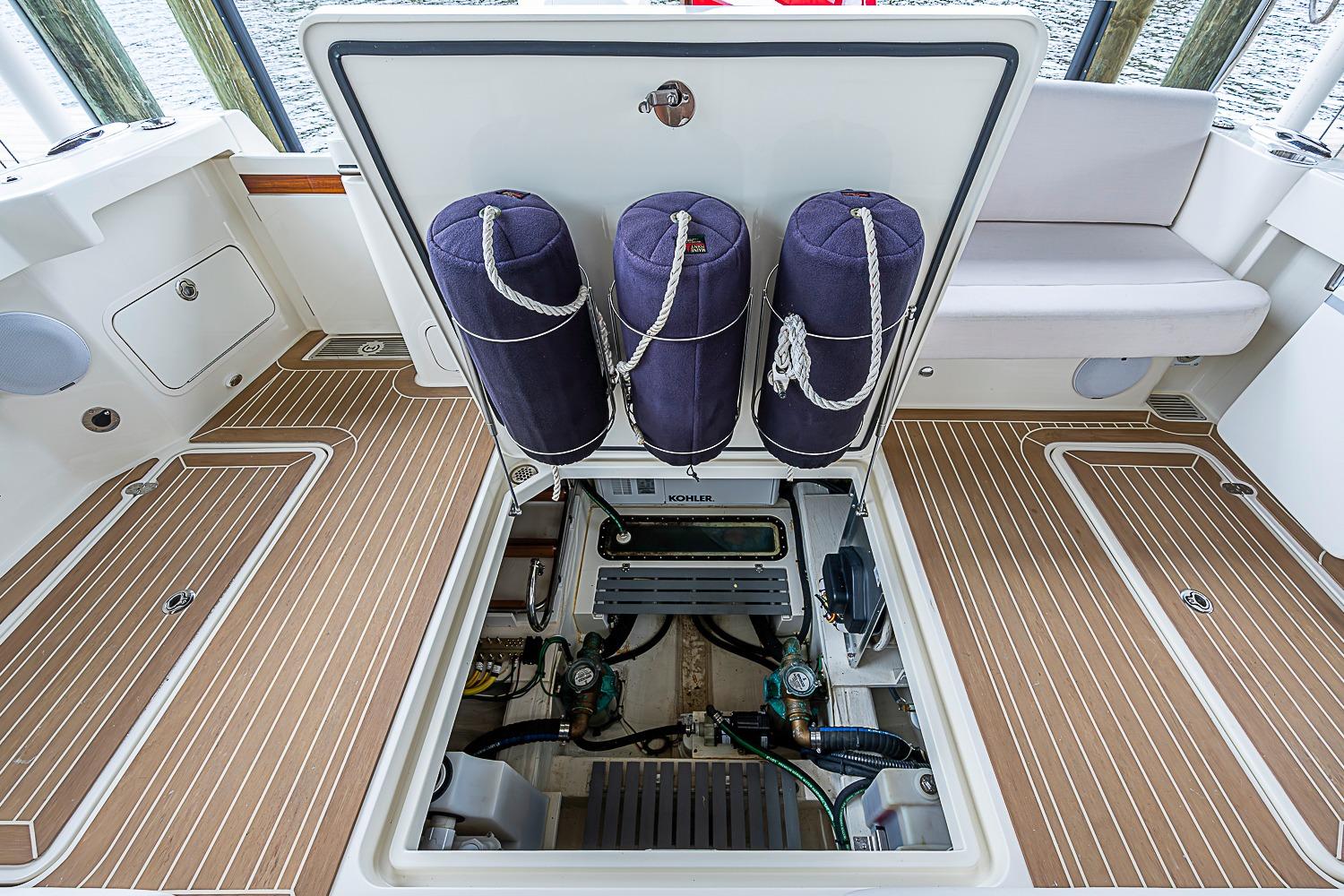 2023 Hinckley Sport Boat 40 X engine compartment with open hatch and fenders.