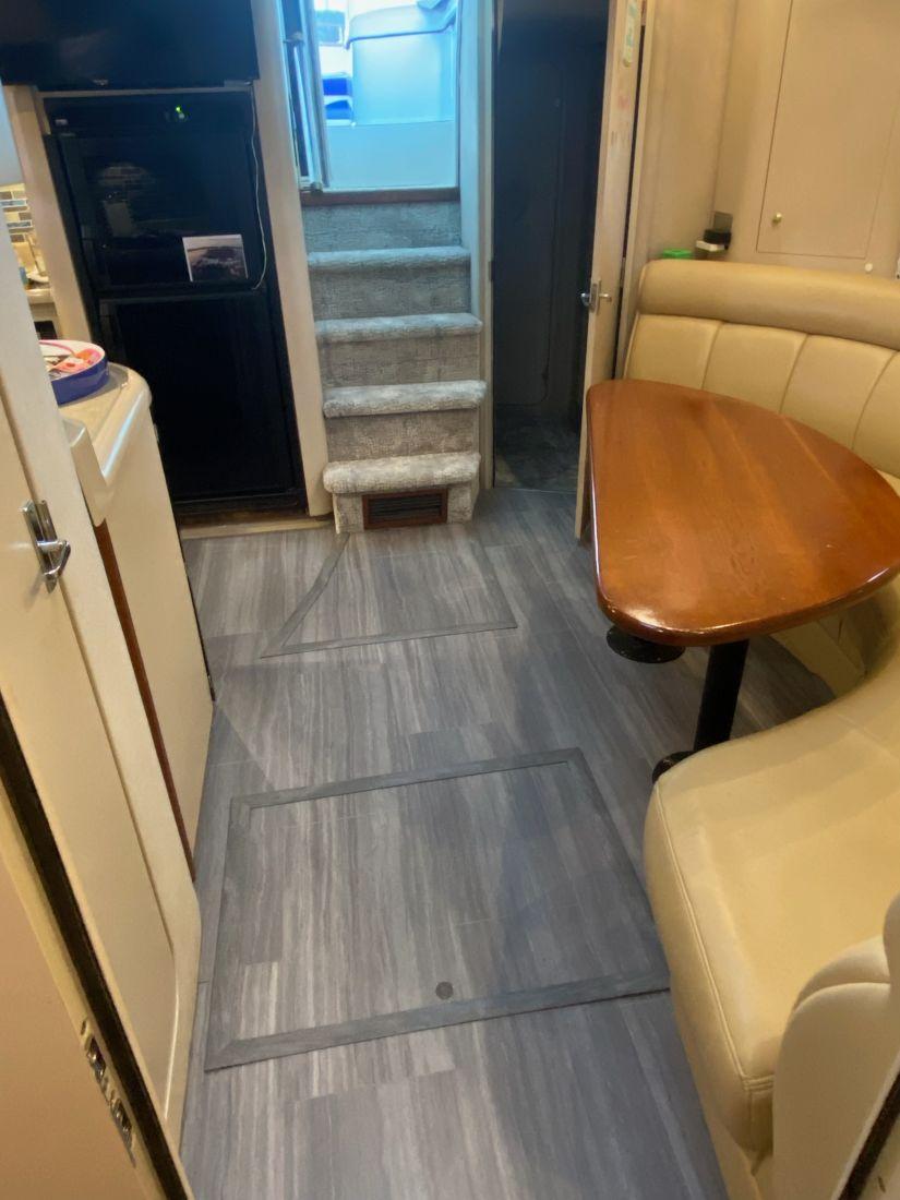 2000 Cruisers Yachts 4270 Express interior with dining area and stairs.
