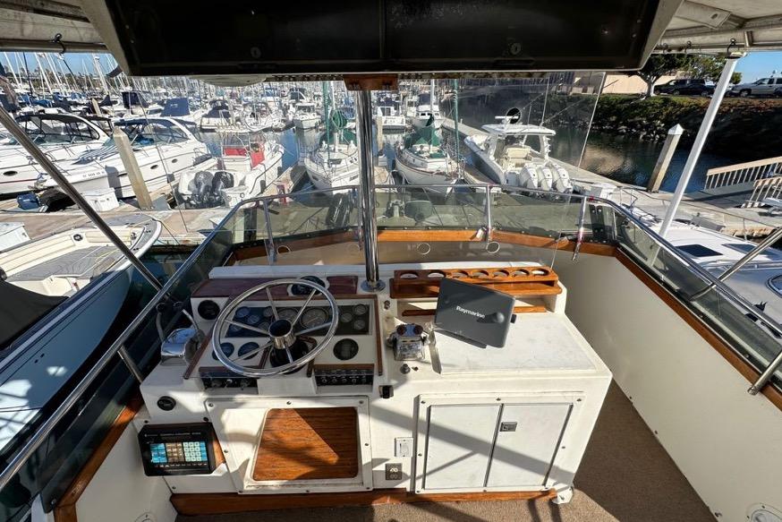 Cockpit view of 1985 Egg Harbor 33 Sedan yacht docked at marina.