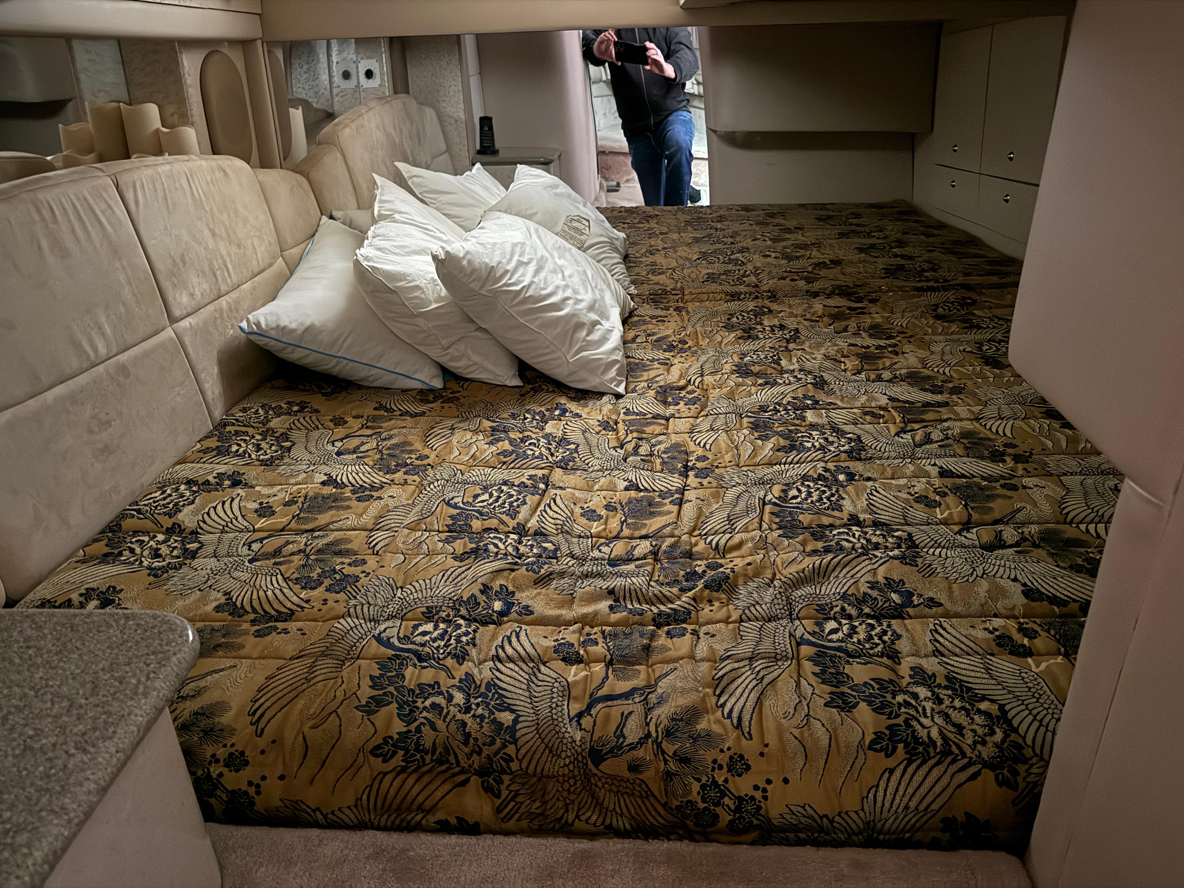 Luxurious cabin interior of 2002 Formula 400 Super Sport with patterned bedding and pillows.