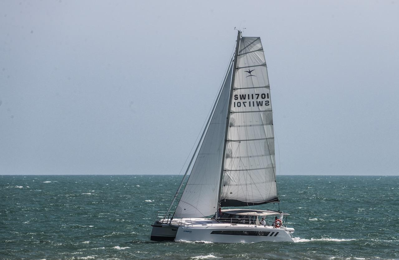 2025 Seawind 1170 catamaran sailing on open sea under clear skies.