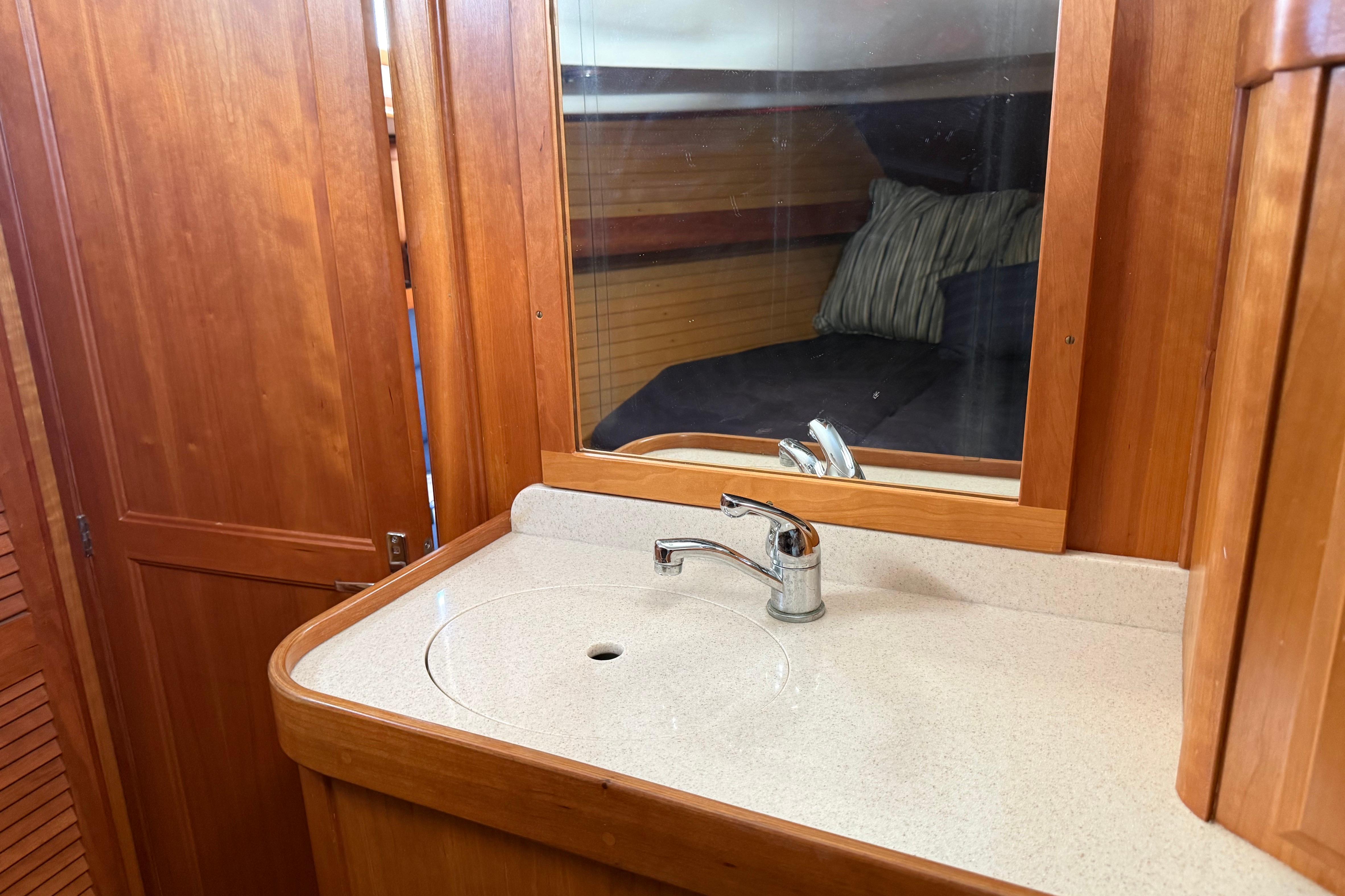 Wooden interior of 2004 Sabre 386 yacht with sink and mirror.