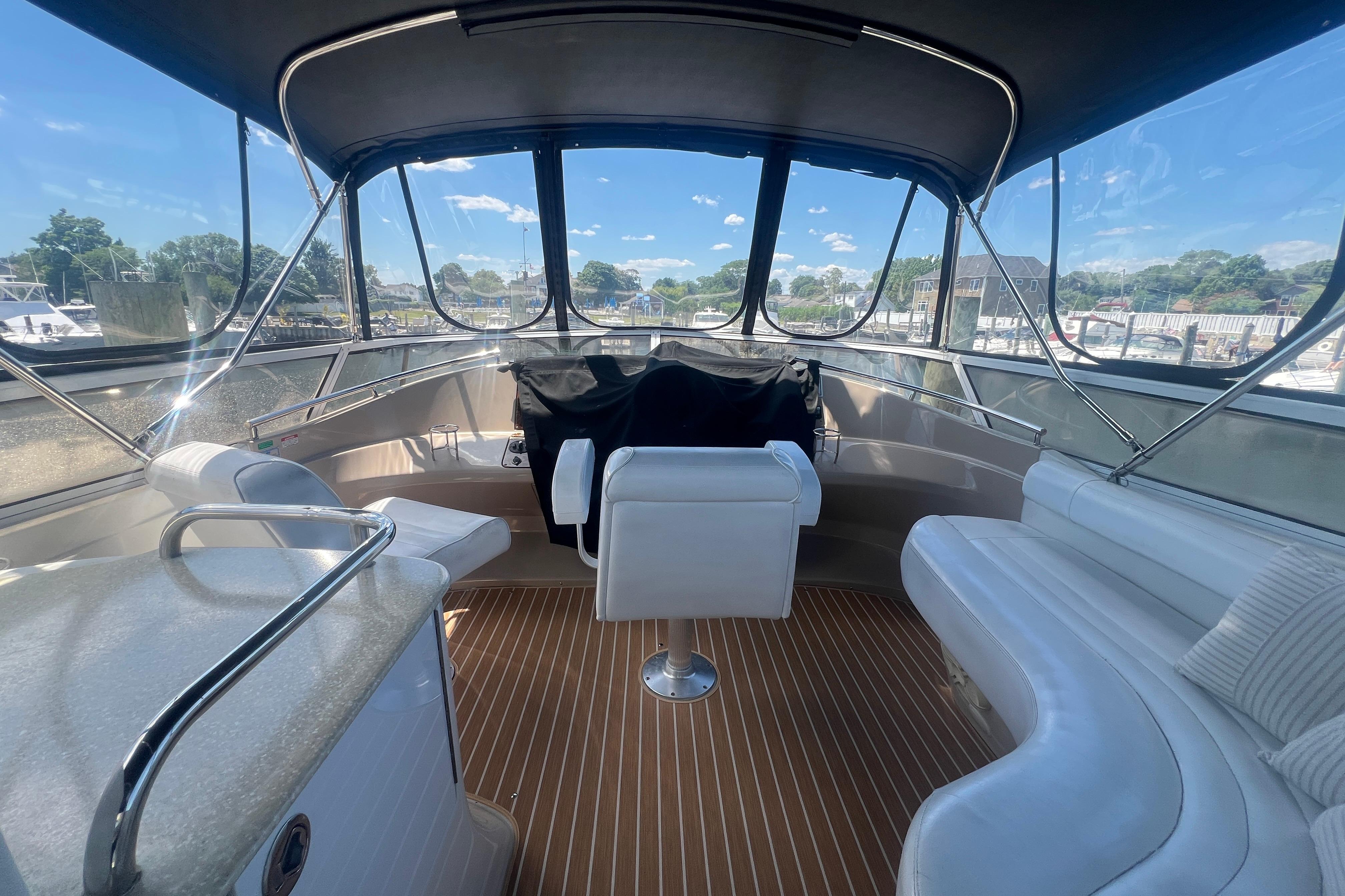 Interior view of 2006 Carver 43 Motor Yacht with seating and helm station.