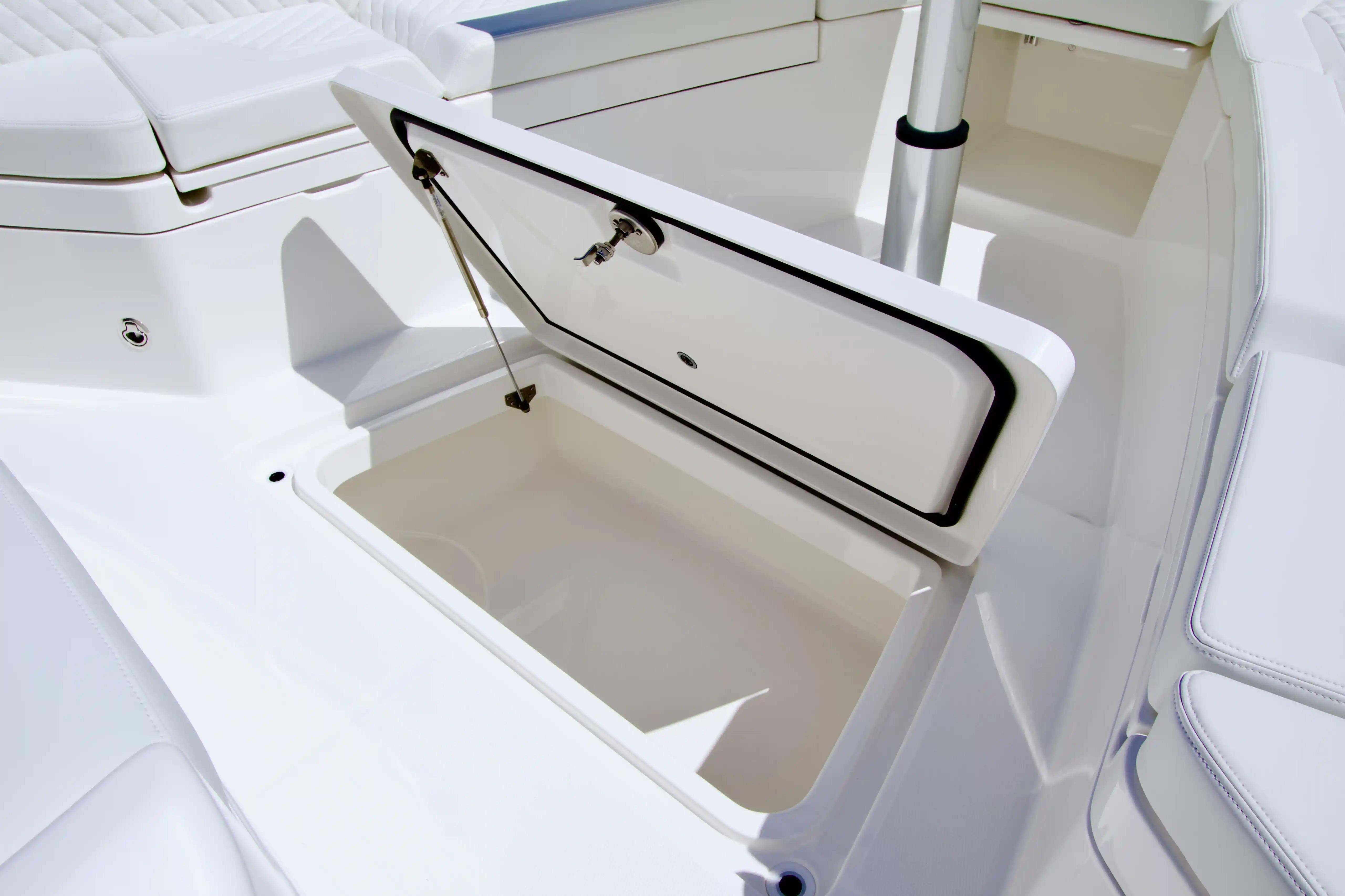 Open storage compartment on 2027 Regulator 35 boat, showcasing sleek white interior design.