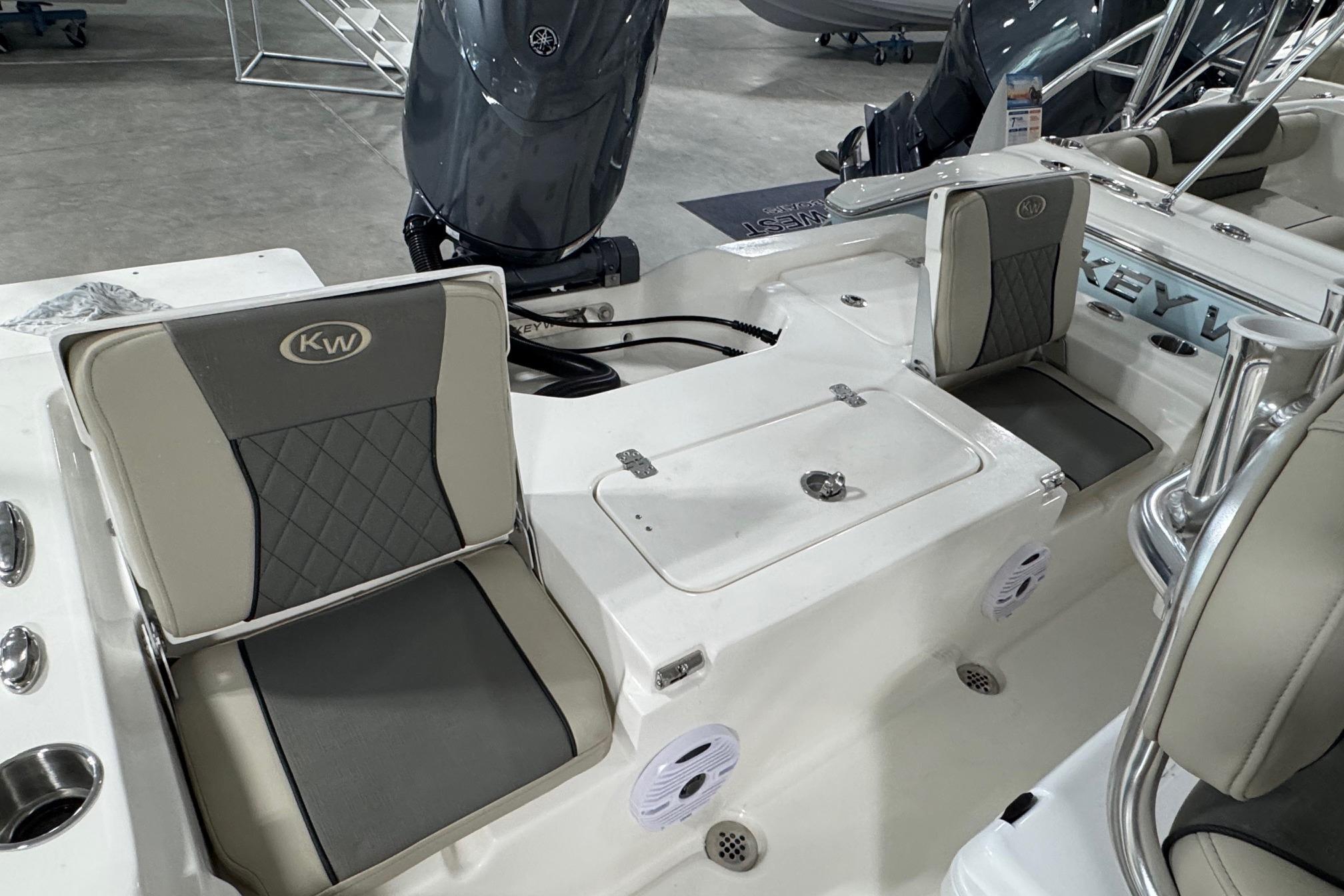 2026 Key West 210 Bay Reef boat interior with cushioned seating and motor.