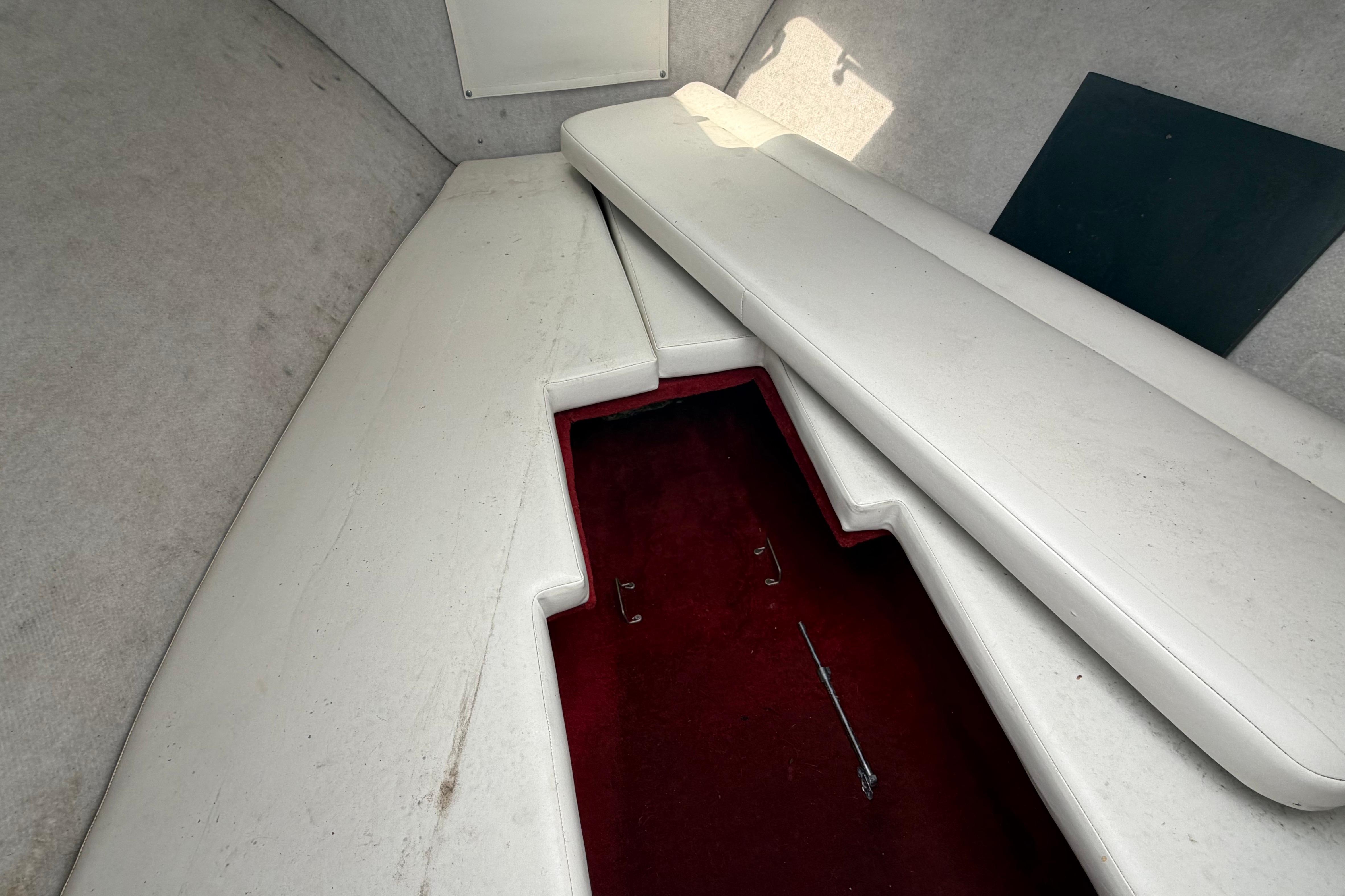 Interior cabin of 1997 Wellcraft 302 Scarab Sport boat with white seating.