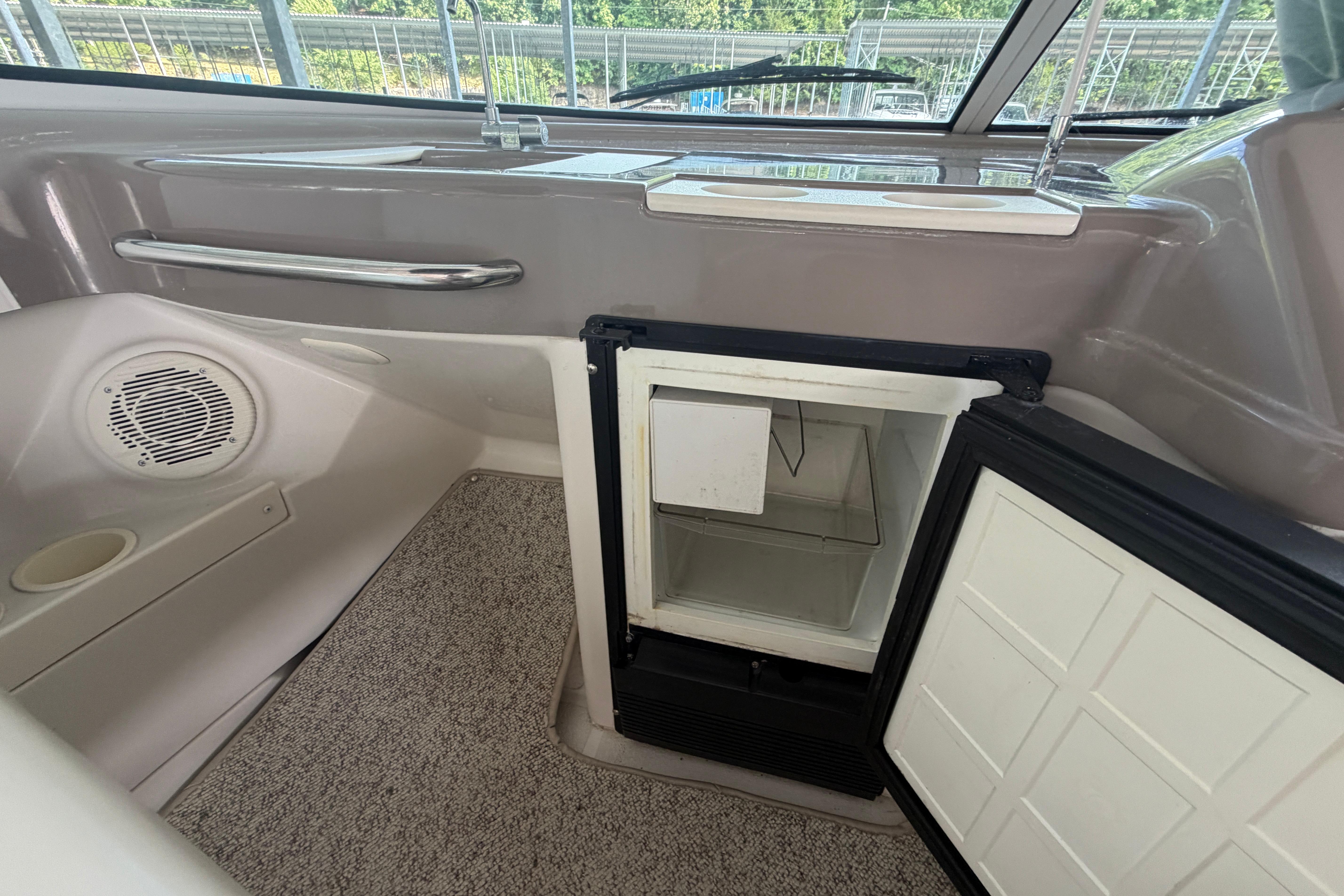 Interior of a 2000 Carver 350 Mariner boat with an open mini fridge.