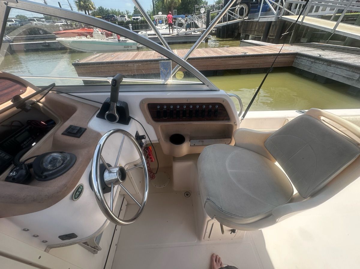 The image shows the cockpit of a 1998 Grady-White Adventure 208 boat.