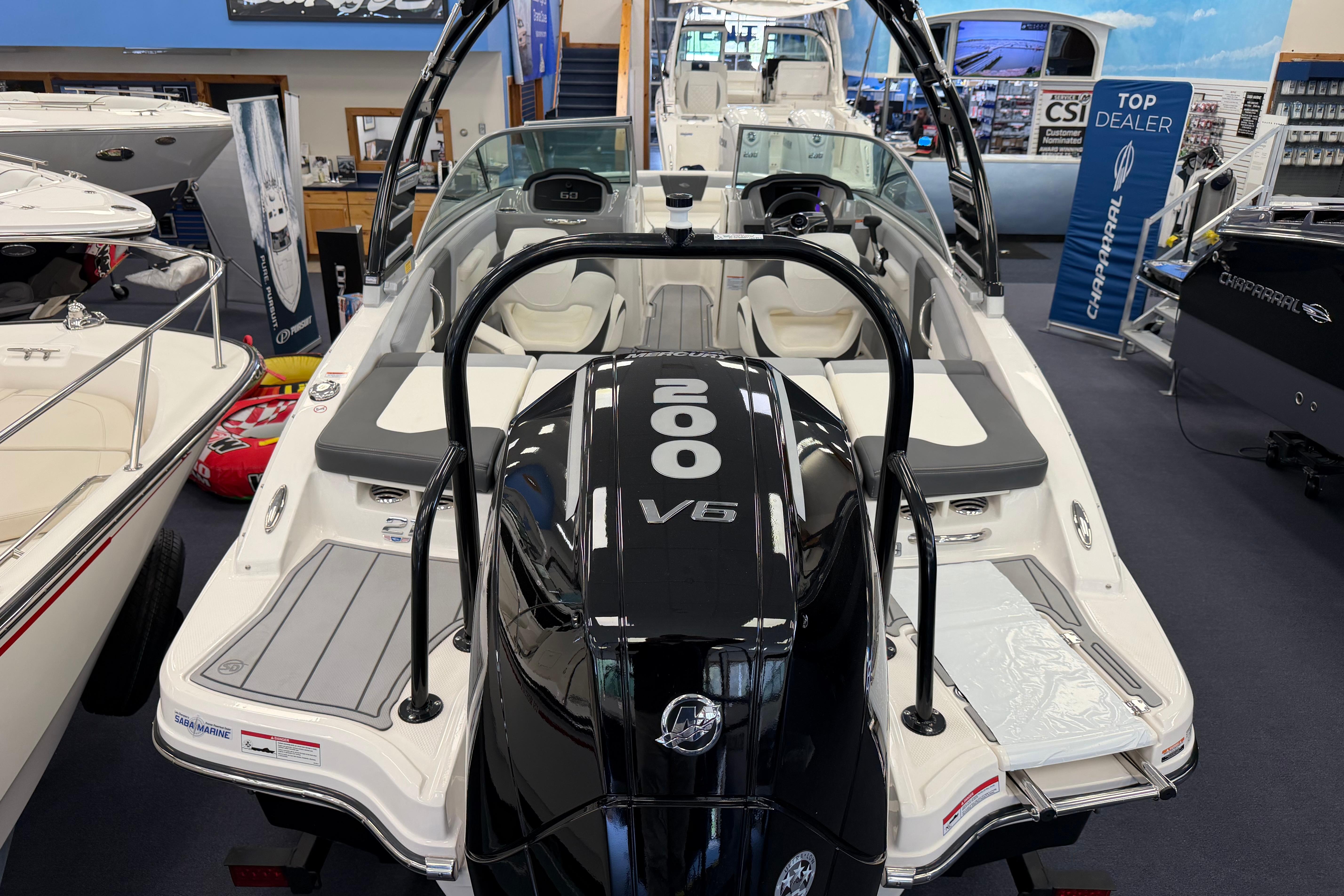 2025 Chaparral 21 SSi OB boat with 200 V6 engine displayed in showroom.