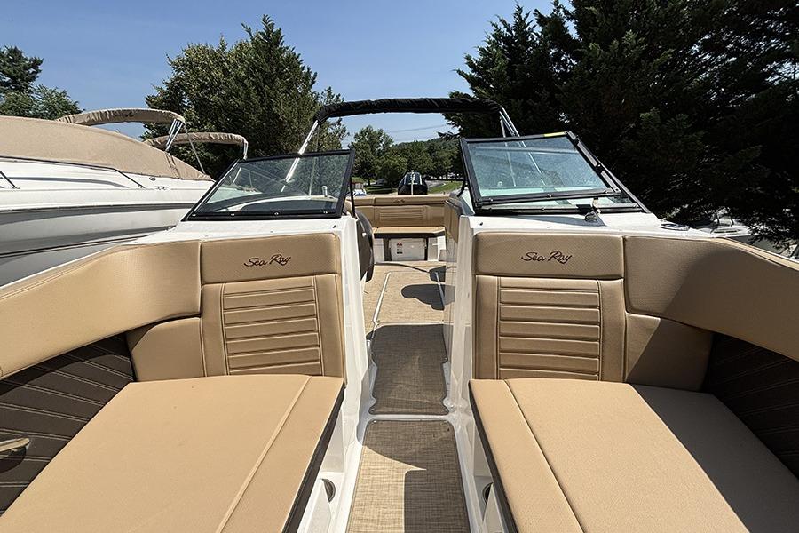 2019 Sea Ray SPX 230 Outboard boat interior with tan seating and open deck.