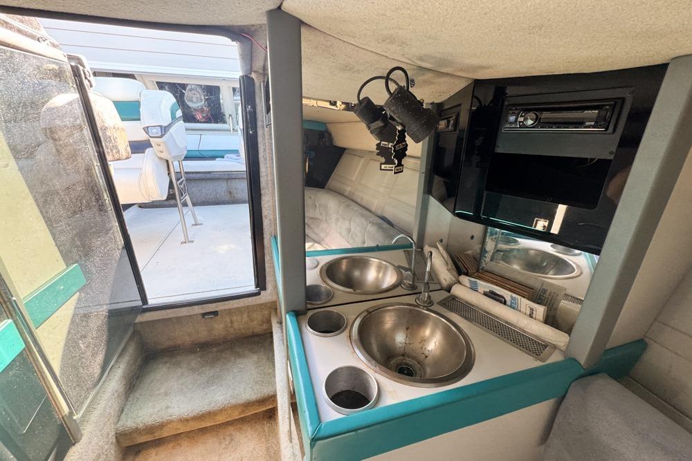1989 Formula 292 SR-1 boat interior with kitchenette, sink, and seating area.
