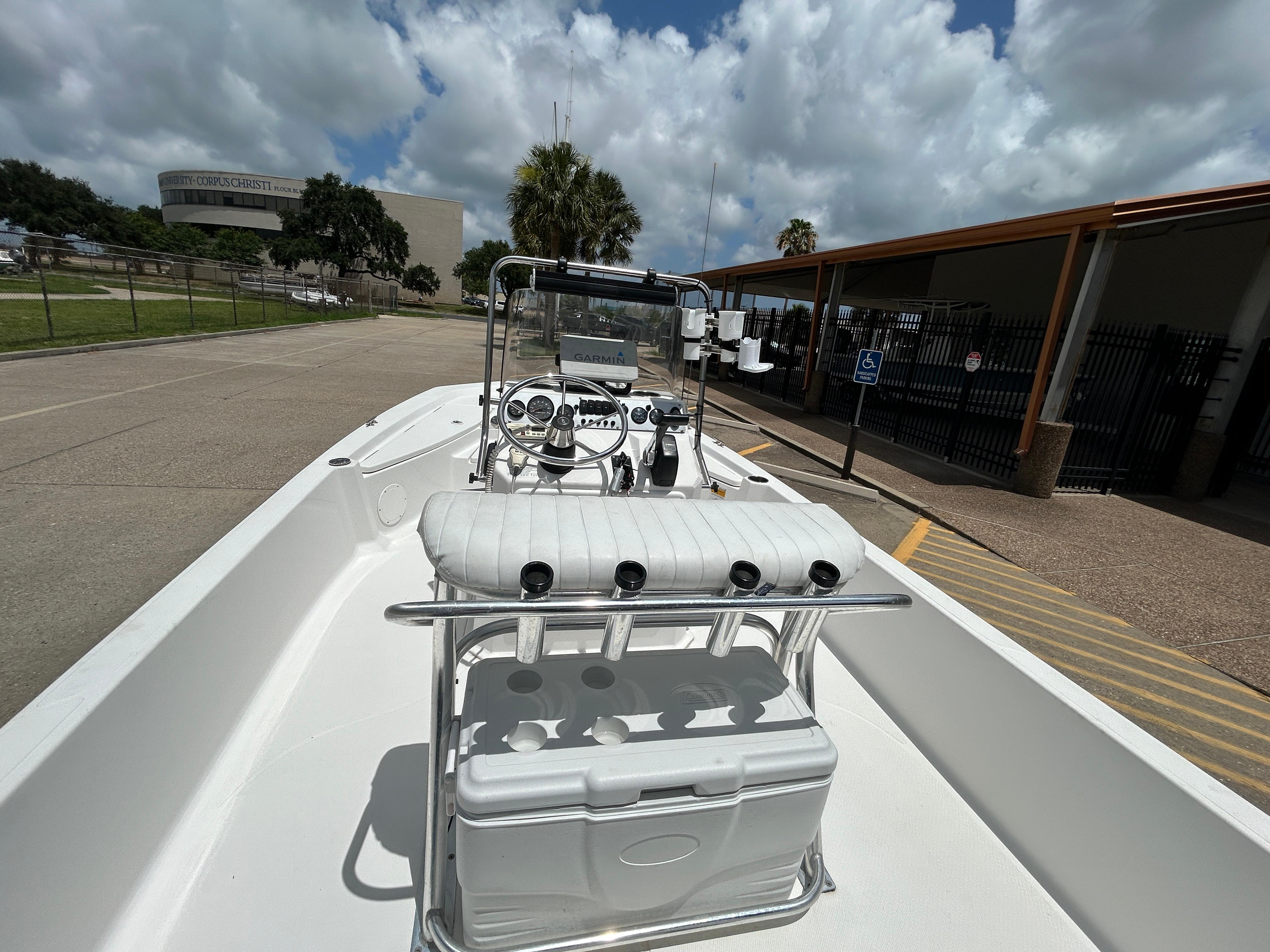 2012 Blue Wave 1900 STL boat parked outdoors under cloudy sky.