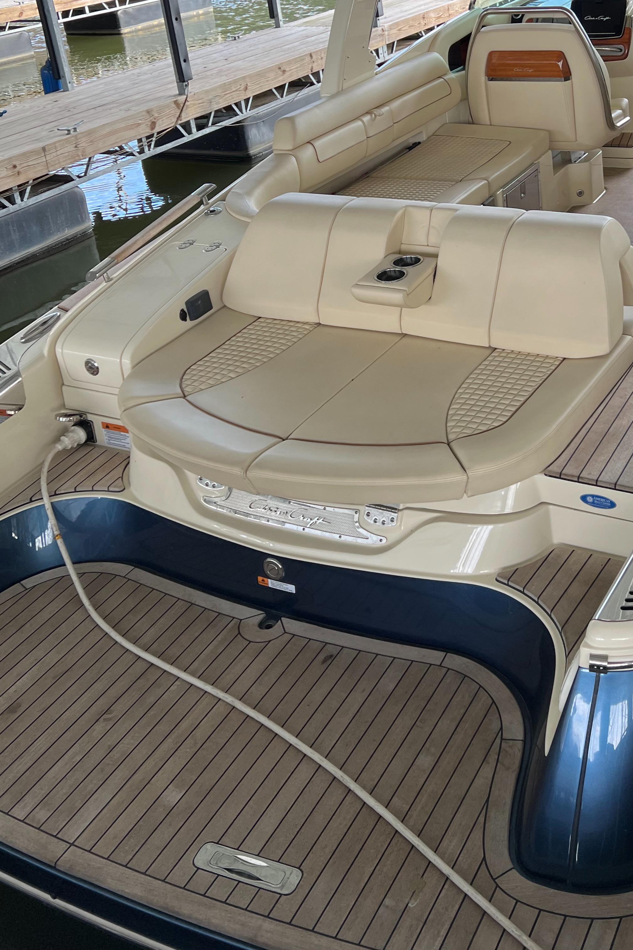 2020 Chris-Craft Launch 31 GT luxury boat interior with beige seating and wooden deck.
