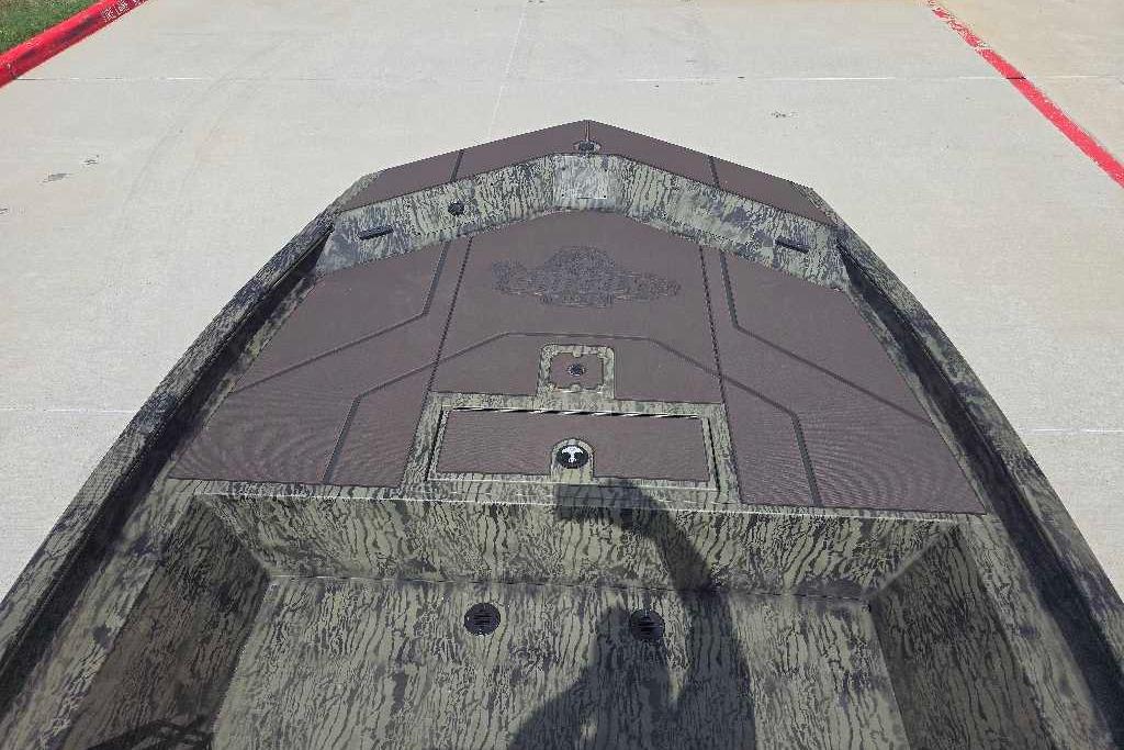 2026 Tracker Grizzly 1860 CC boat deck with camouflage pattern, photographed outdoors.