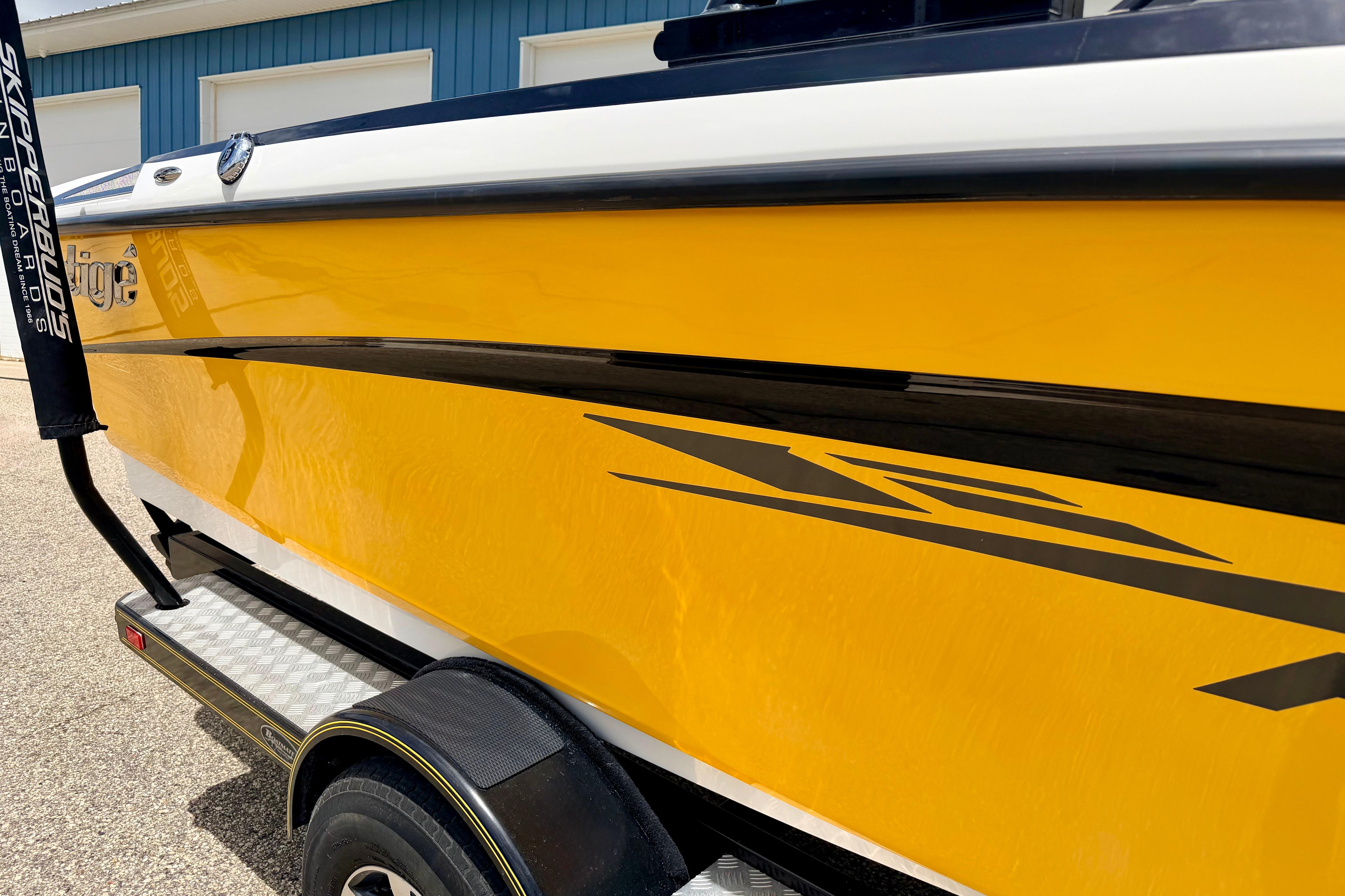 2014 Tigé R20 boat with vibrant yellow exterior and sleek black accents.