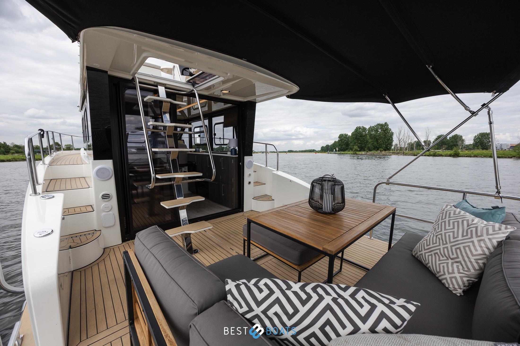 2023 Cobra Yachts Futura 36 Premium Fly, luxurious deck with seating and scenic water view.
