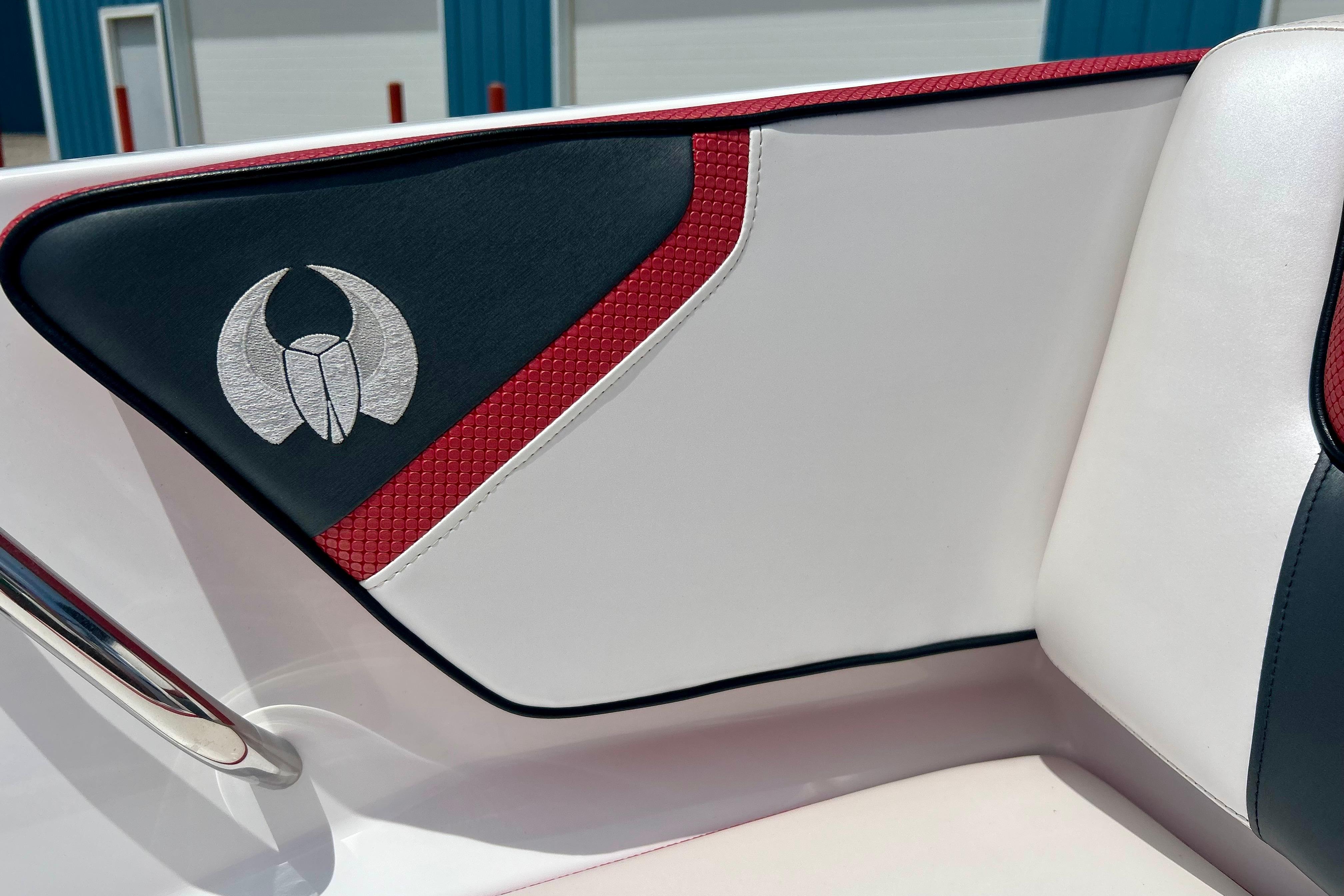 Interior detail of 2021 Scarab 195 ID boat with red and black accents.
