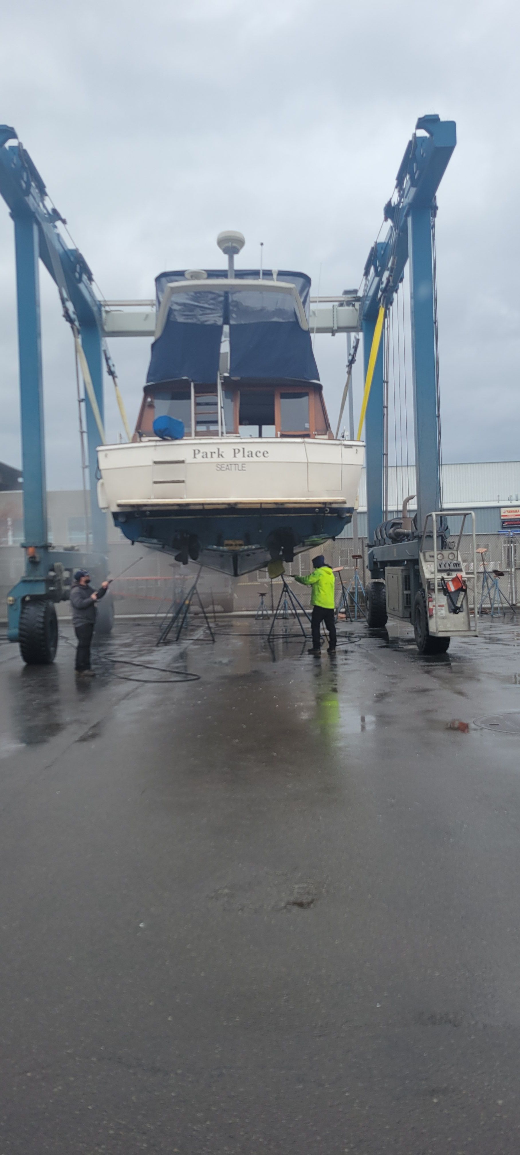 1984 Bayliner 3870 Motoryacht in dry dock with workers.