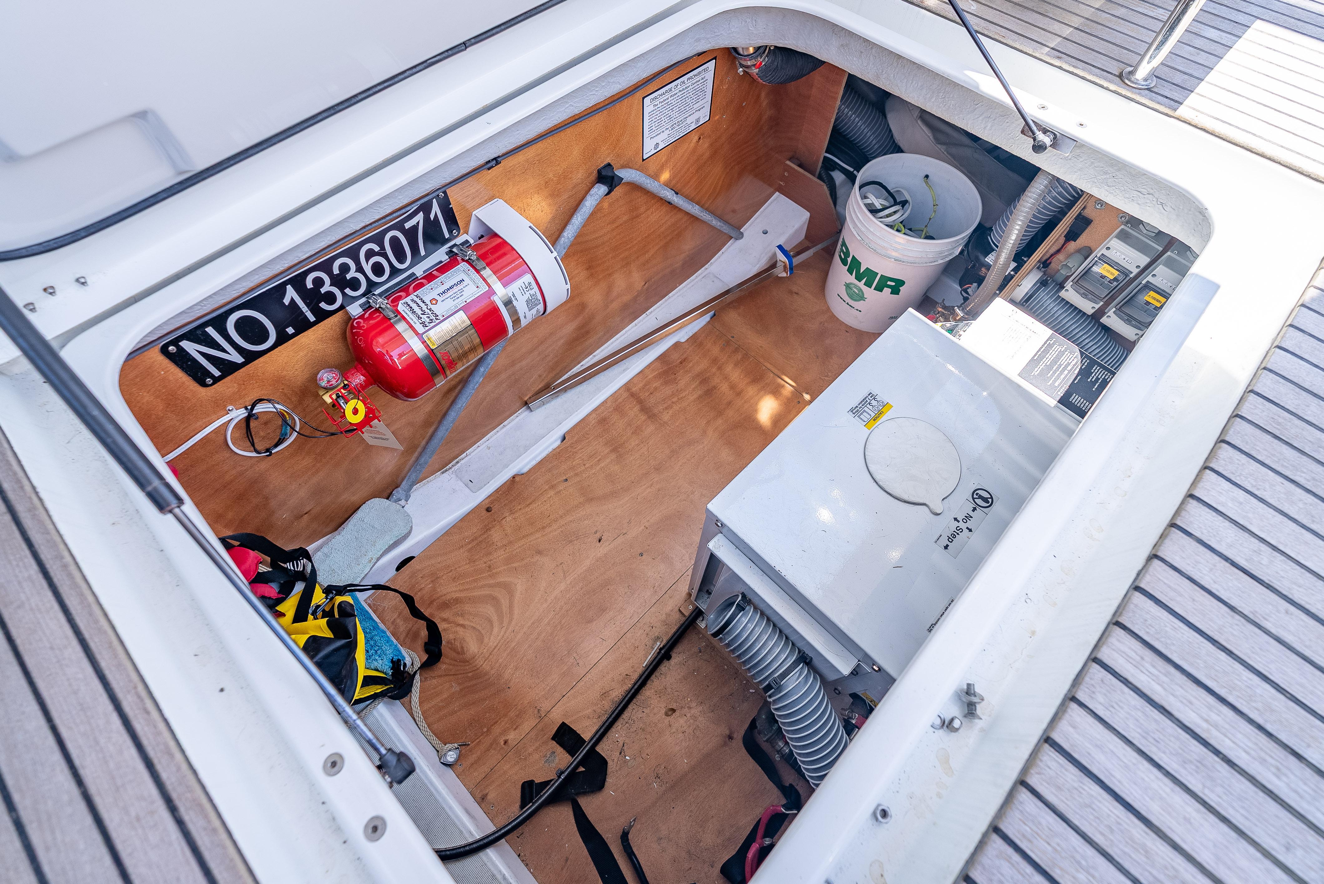 Engine compartment of 2015 Beneteau Swift Trawler 34 with fire extinguisher and equipment.
