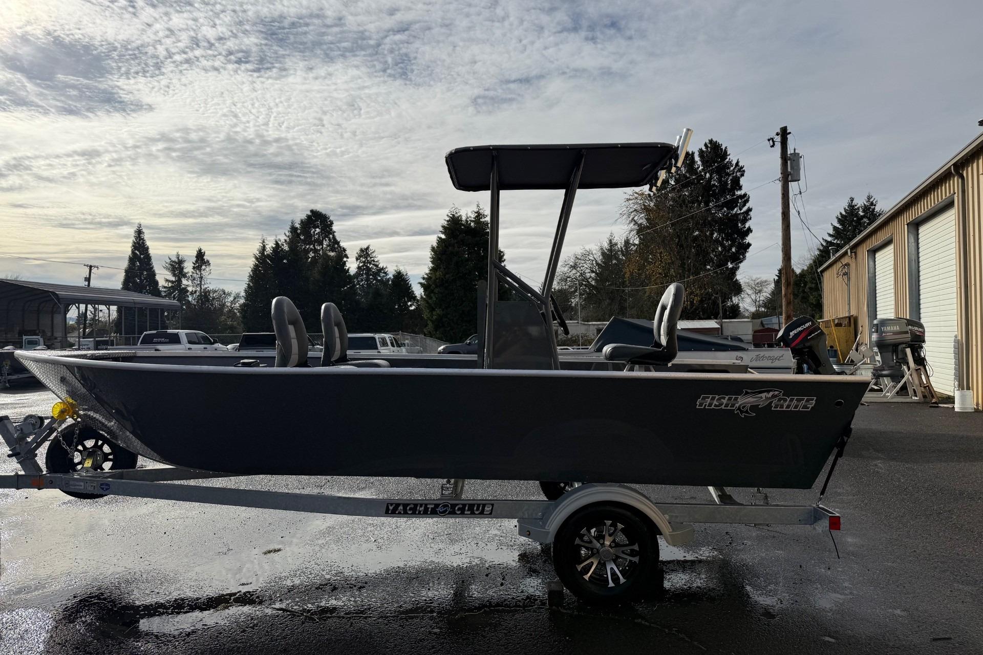2026 Fish Rite Angler 18 boat on trailer, parked outdoors under cloudy sky.