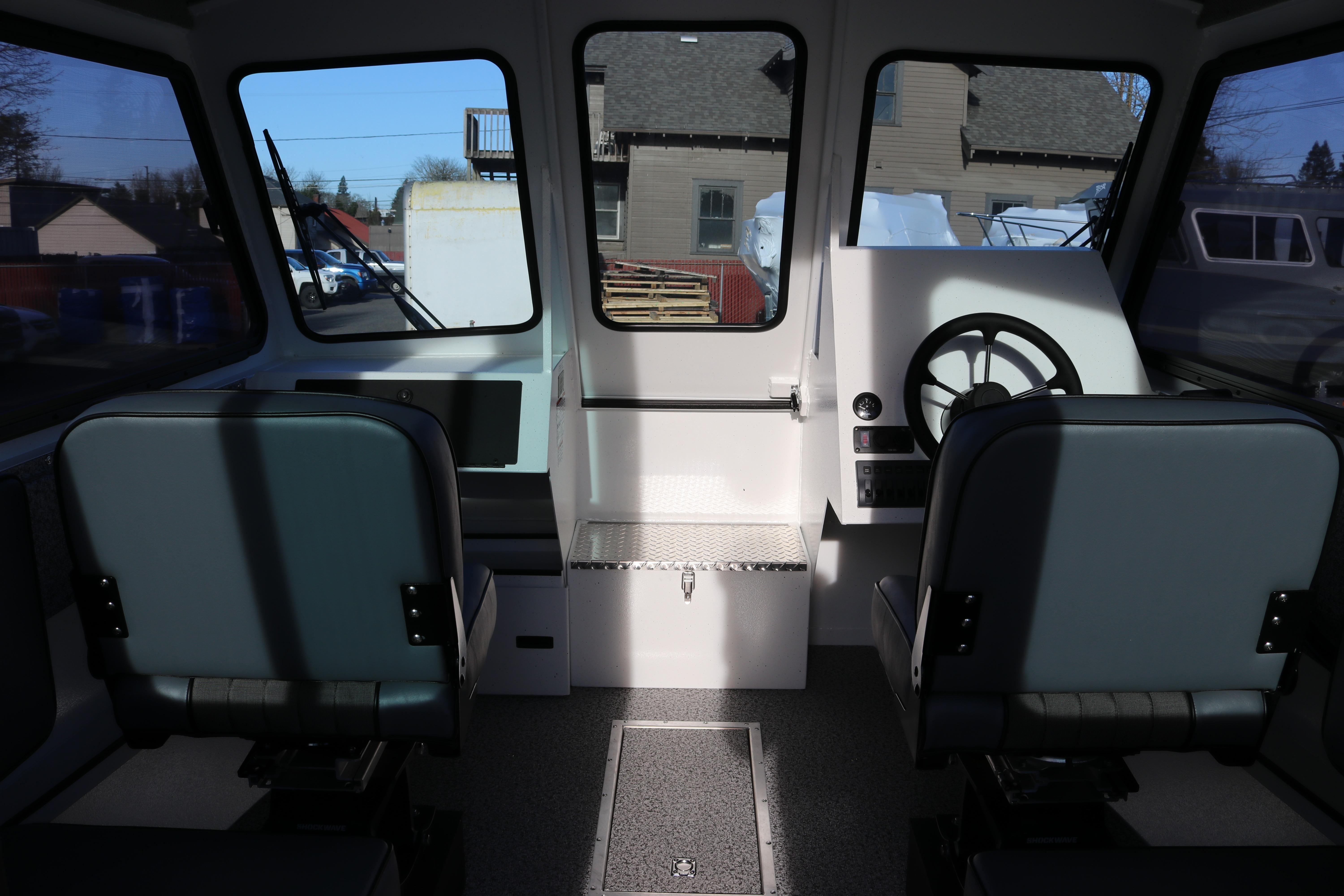 Interior of 2026 Alumaweld Intruder Outboard 22 boat, featuring dual seats and steering console.