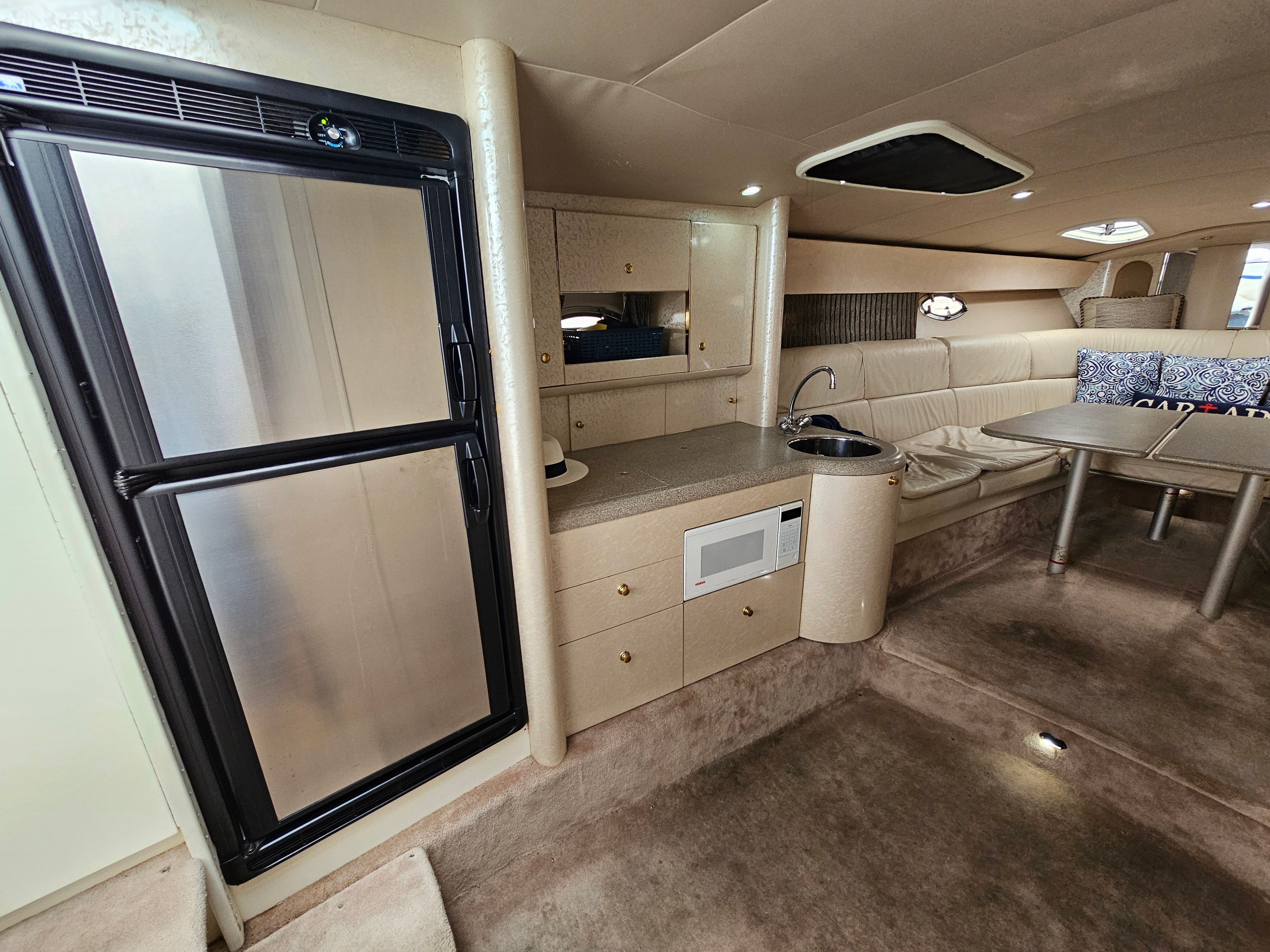 Interior of a 2001 Formula 400 Super Sport with kitchenette, seating area, and refrigerator.